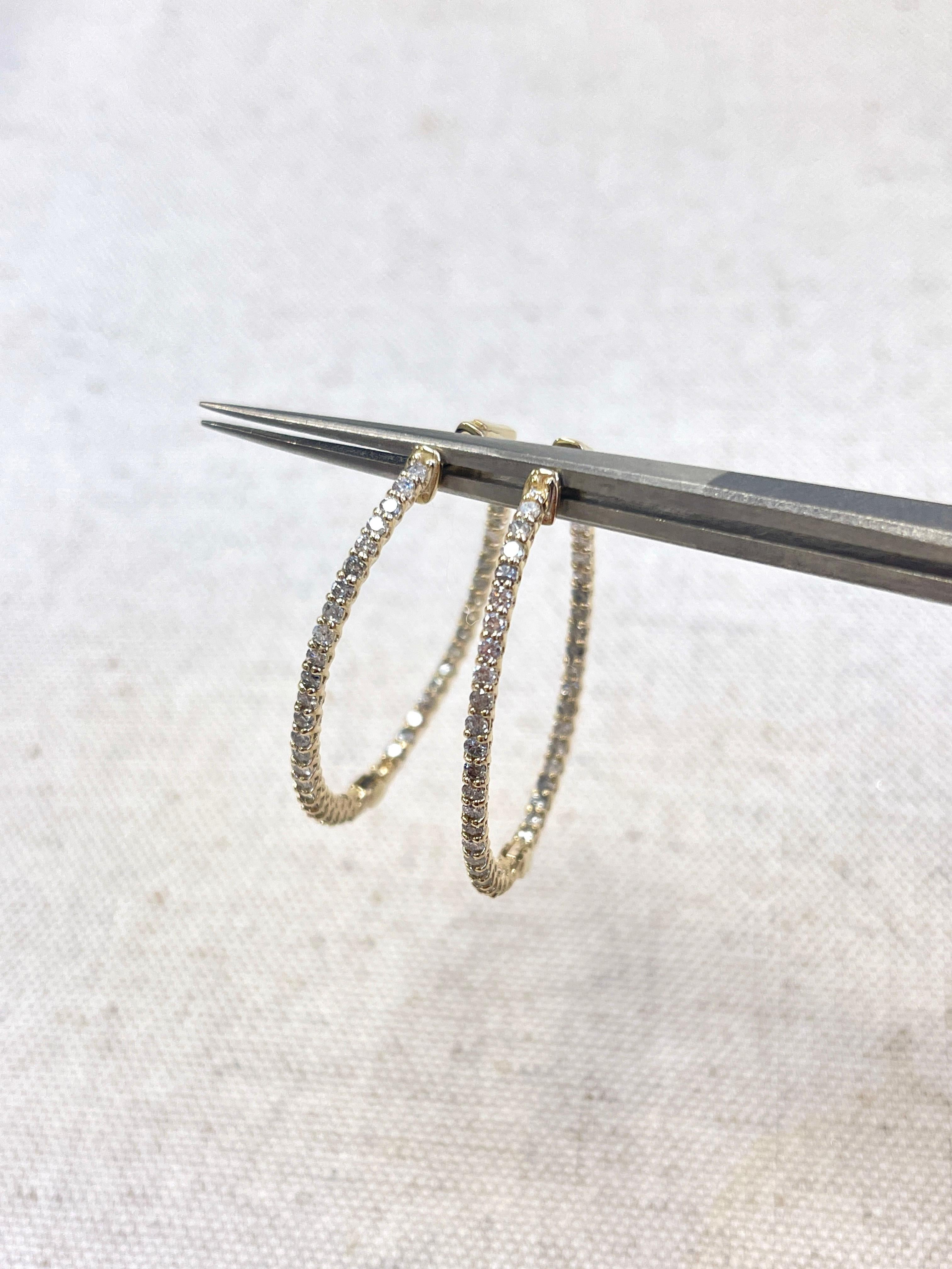 Beautiful pair of natural diamond inside out oval hoop earrings in 14k yellow gold. Secures with snap closure for wear. Average Color G, Clarity I, Measures 1.40 inch. 
