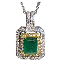 Antique 1.45 Carat Emerald Cut Emerald Diamond Halo Pendant