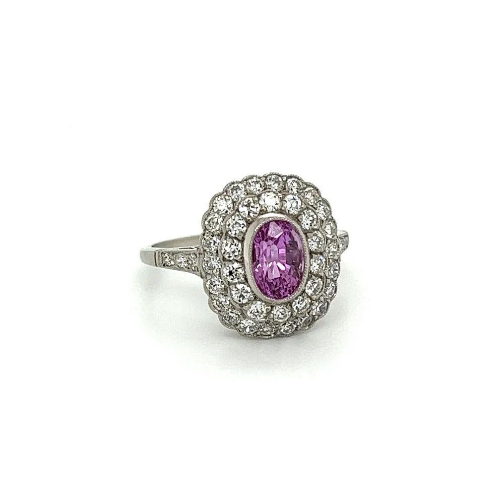 Simply Beautiful! Finely detailed Pink Sapphire and Double Halo Diamond Platinum Cocktail Ring. Centering a securely nestled oval Pink Sapphire, weighing approx. 1.45 Carats surrounded by OEC Diamonds, weighing approx. 0.90tcw. The ring is Hand