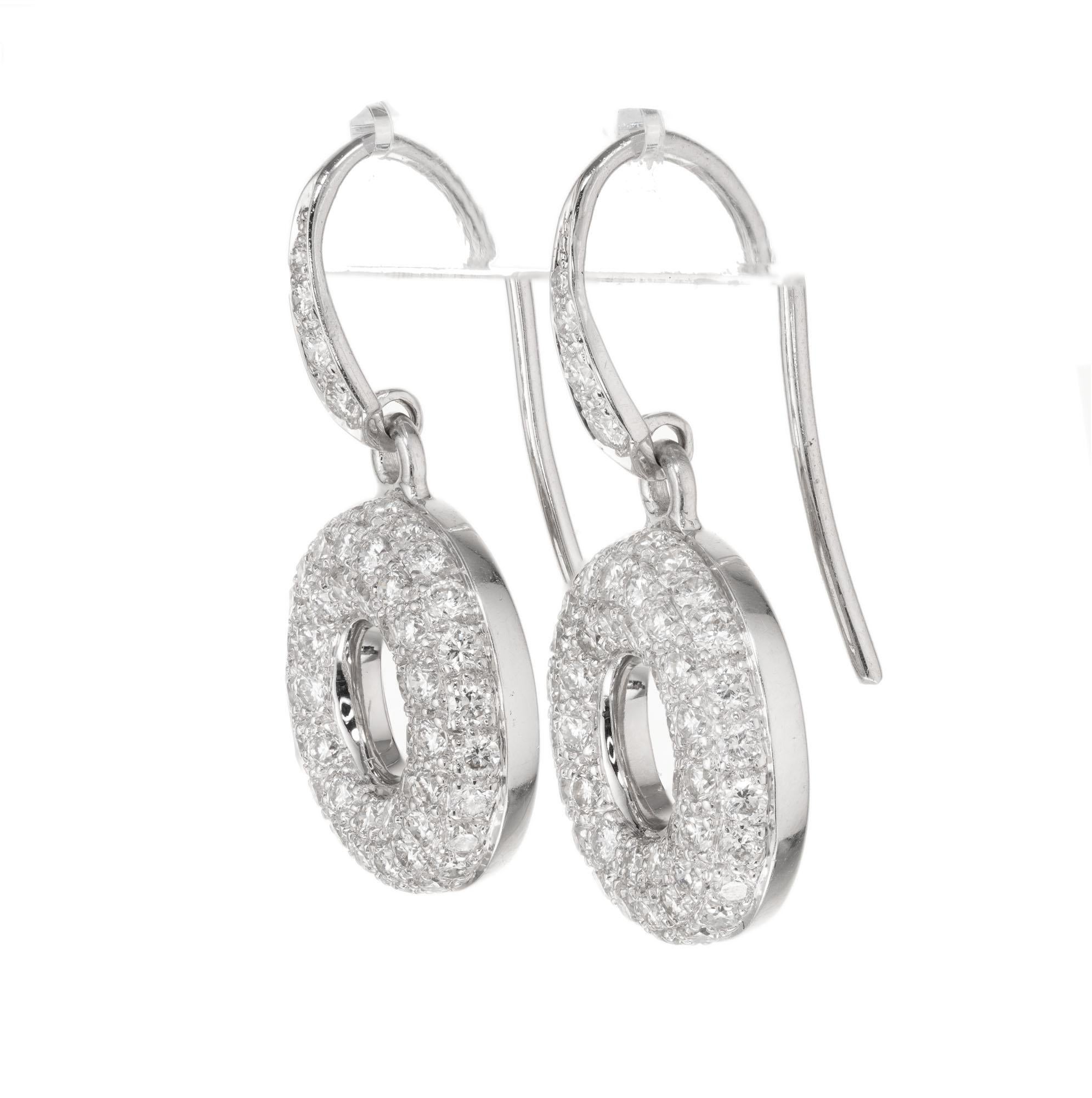 Diamond dangle earrings with round brilliant cut pave set diamonds. Open circle design suspended from graduating diamonds in 18k white gold.

116 round brilliant cut diamonds, G VS-SI approx. 1.45 total carat weight
18k white gold 
Stamped: 18k
5.4