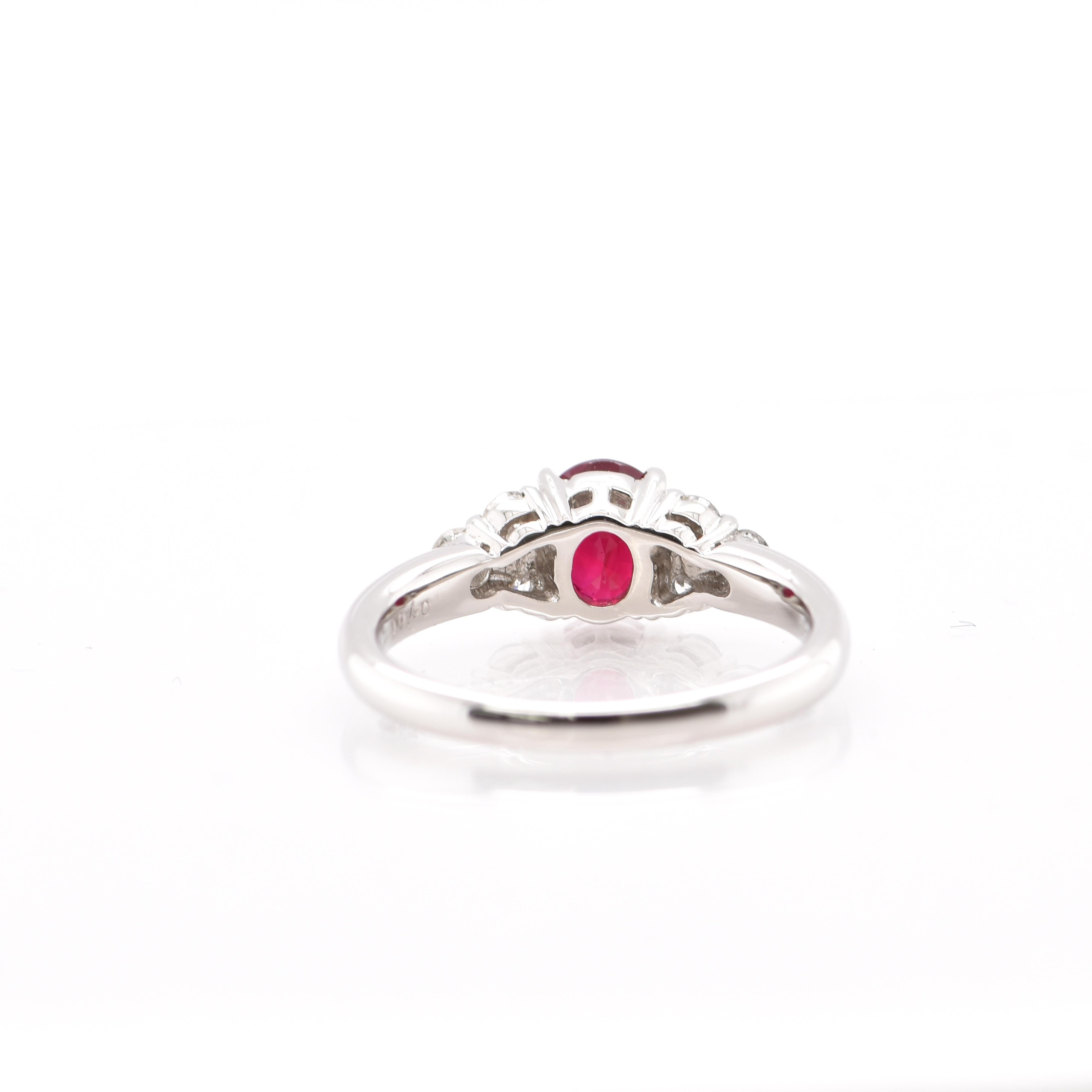 A beautiful Engagement Ring featuring a AIGS Certified 1.45 Carat Pigeon's Blood Burmese Ruby and 0.40 Carats of Diamond Accents set in Platinum. Rubies are referred to as 