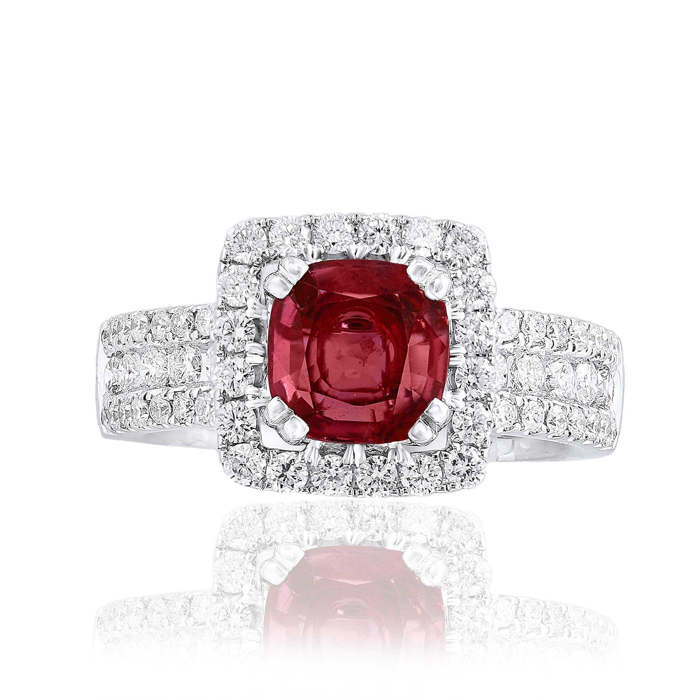 Features a beautiful 1.45 carat Ruby at the center. Framed by 1 row of brilliant round diamonds. Diamonds also set halfway all over the shank of the ring. The weight of the 68 diamonds is 0.96 carats. Made in 18k white gold. Size 6.5 US