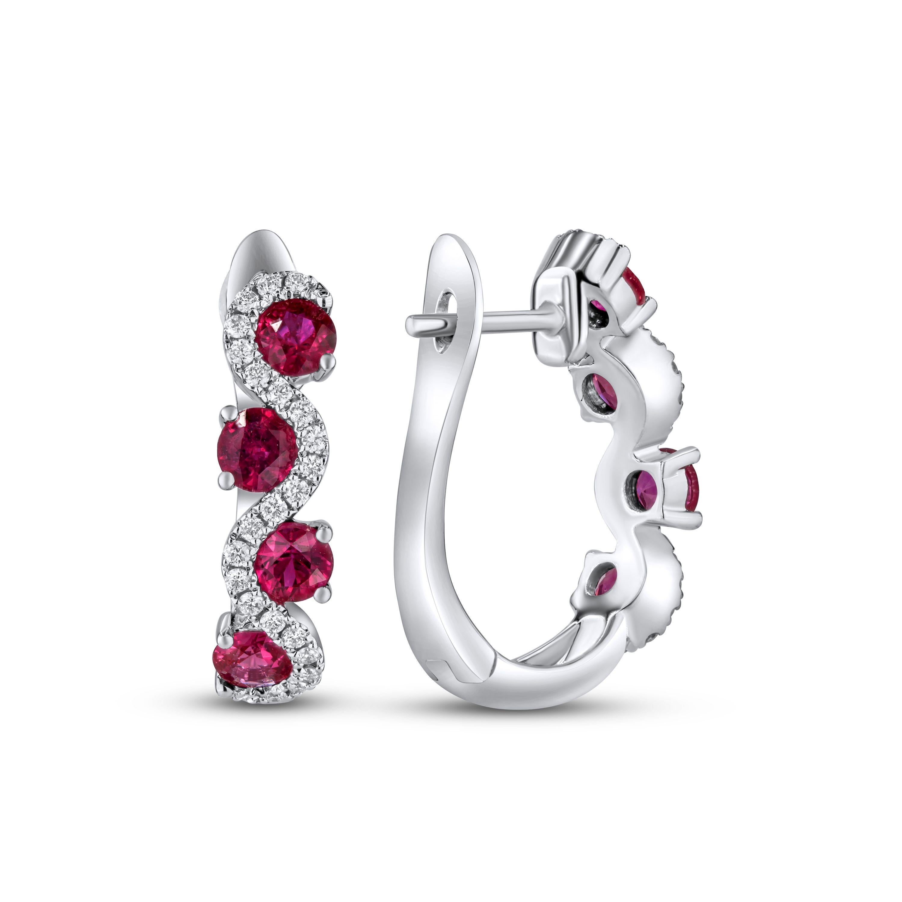 The centerpiece of these earrings is the 1.45 carats of round rubies, each one meticulously selected to radiate a deep, passionate red hue. These vibrant gemstones are perfectly nestled within a delicate wave of round natural diamonds, totaling 0.21
