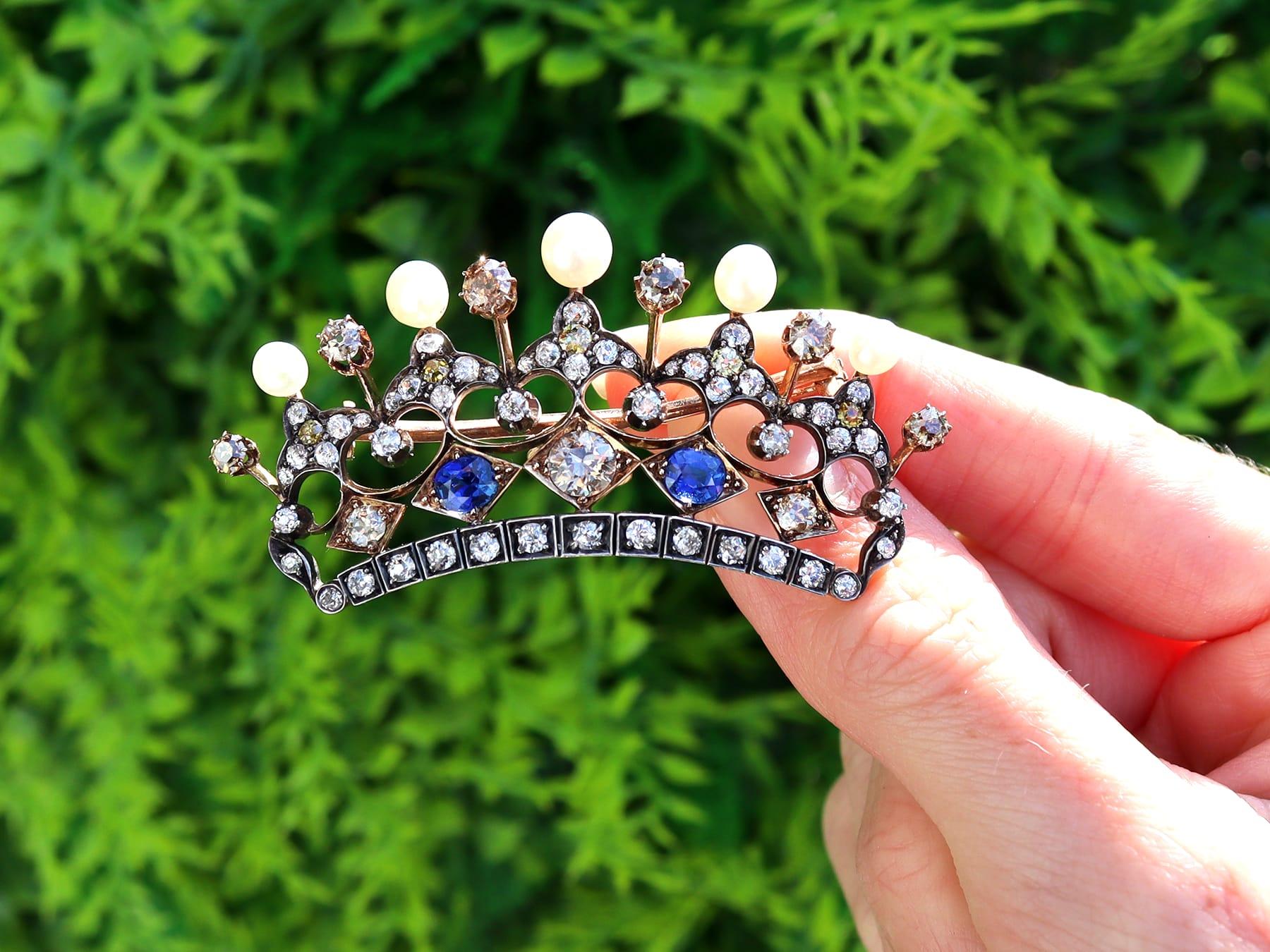 A magnificent, stunning, fine and impressive 1.45 carat sapphire, 6.16 carat diamond and natural pearl, 9 karat yellow gold and silver set crown brooch; part of our diverse array of Victorian brooches.

This magnificent, fine and impressive antique