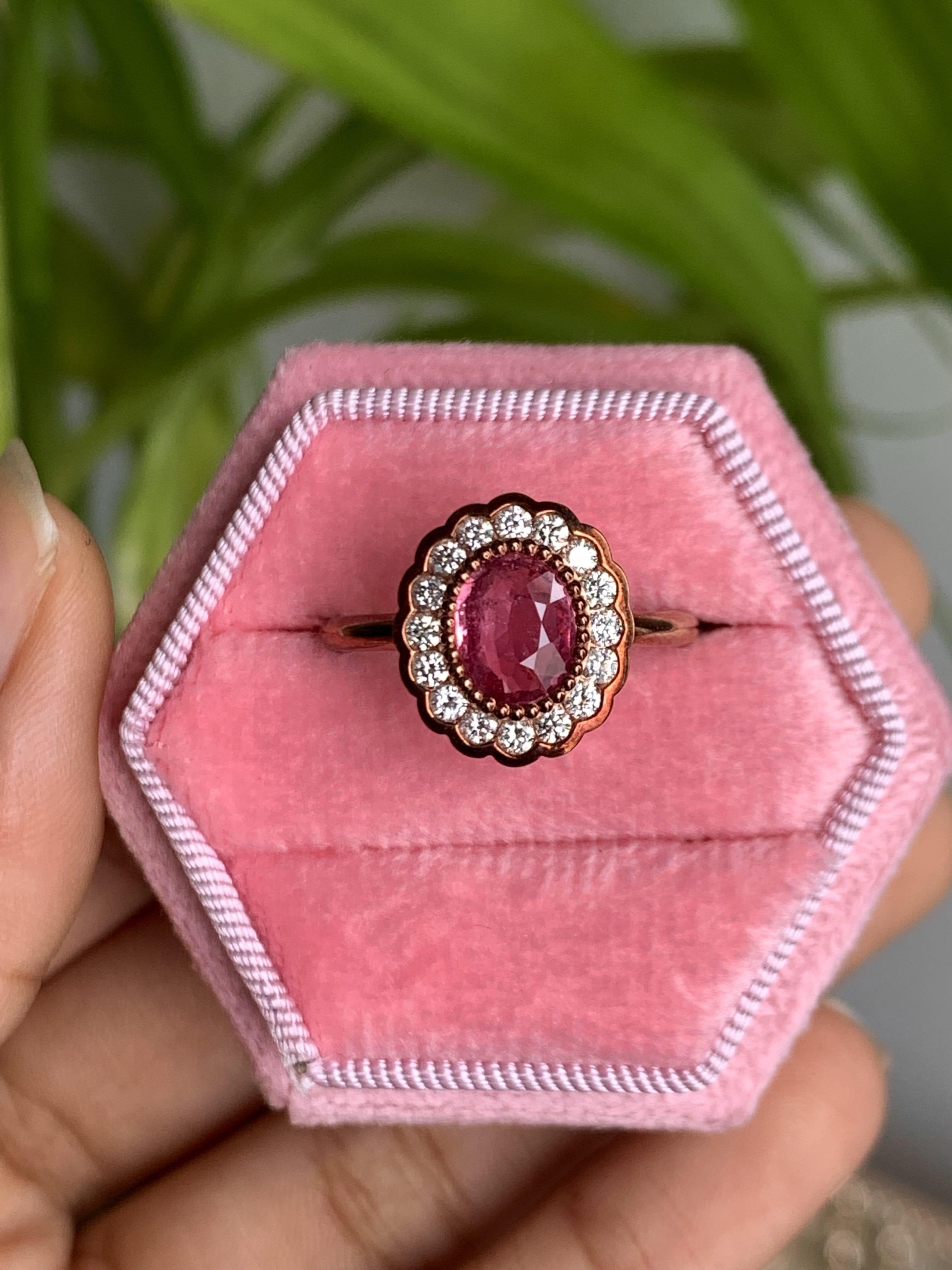 Prepare to be smitten by the sheer beauty of this absolutely fascinating Padparadscha Sapphire Ring. From the moment you lay your eyes on it, you'll fall head over heels in love. Originating from Madagascar, this oval-shaped Padparadscha Sapphire