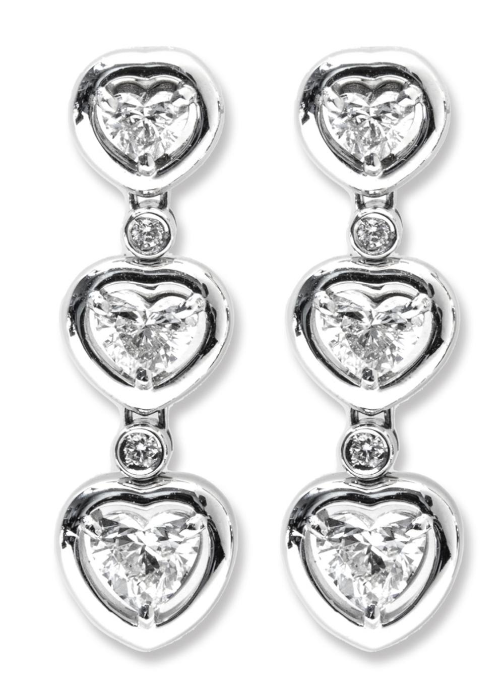 These enchanting earrings stand as a testament to the enduring beauty of love, embodied in every facet.
Expertly crafted in the finest 18K white gold, these stud earrings showcase three heart-cut diamonds, boasting a total of 1.45 carats. The