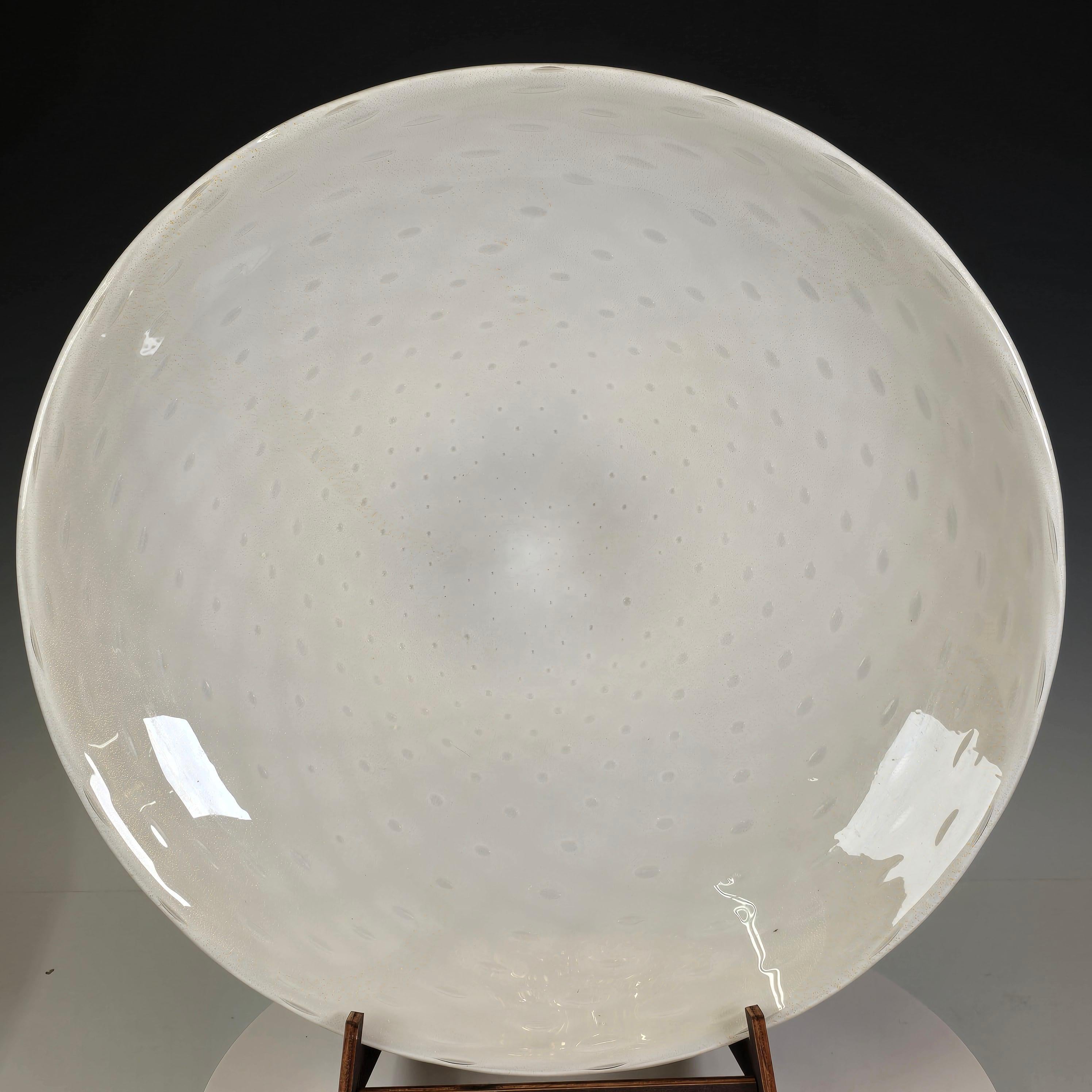 An exceptional large shallow bowl or deep plate crafted in lattimo glass with delicate gold leaf inclusions, made by the legendary Seguso family of Murano, whose name has been synonymous with Venetian glass since the 14th century.

The soft, opaque