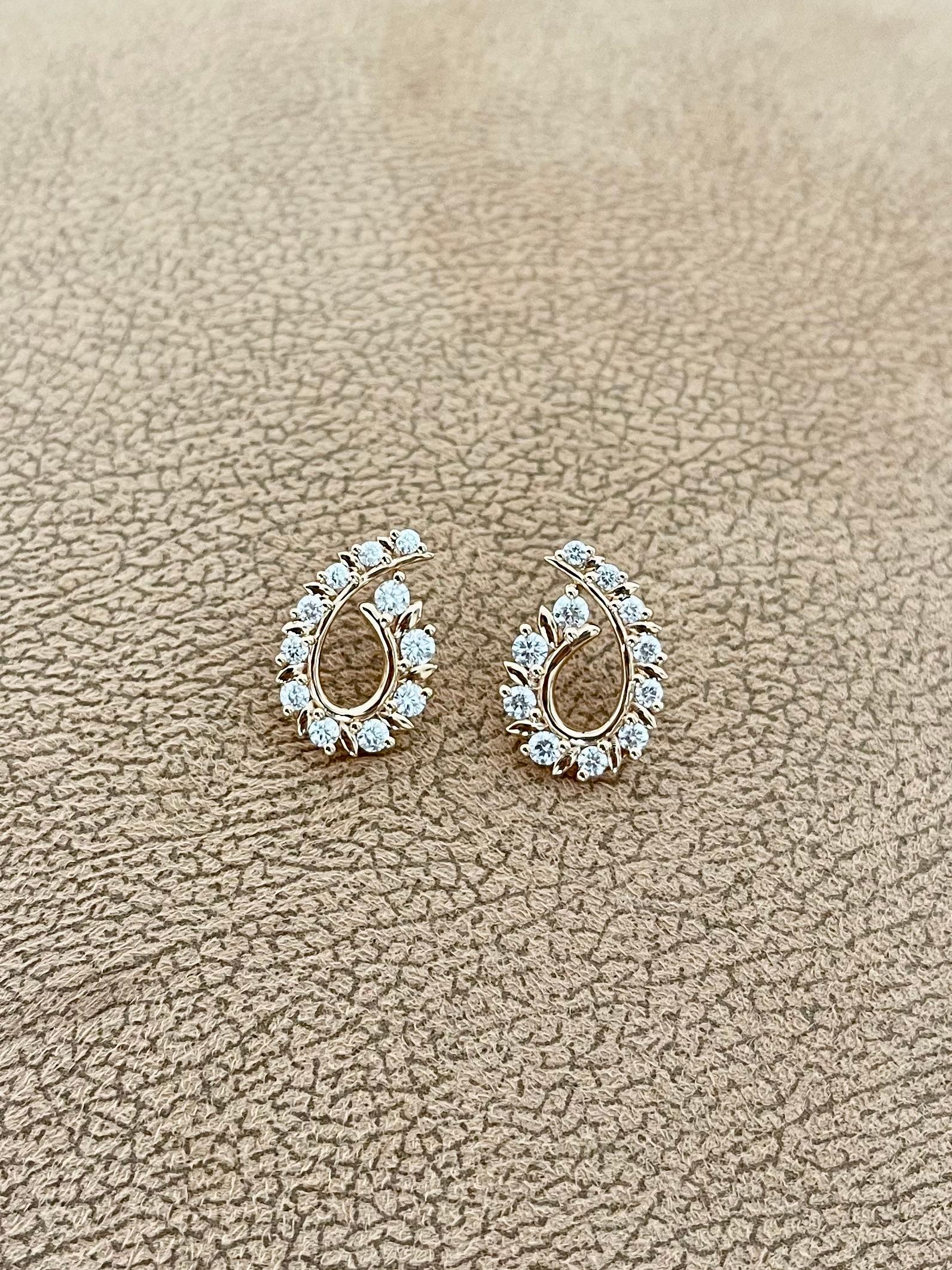 These captivating diamond earrings boast a dazzling 1.45 total carat weight of round brilliant diamonds, set in luxurious 18K rose gold. The soft, feminine blush of the rose gold beautifully complements the sparkling diamonds, creating a look that