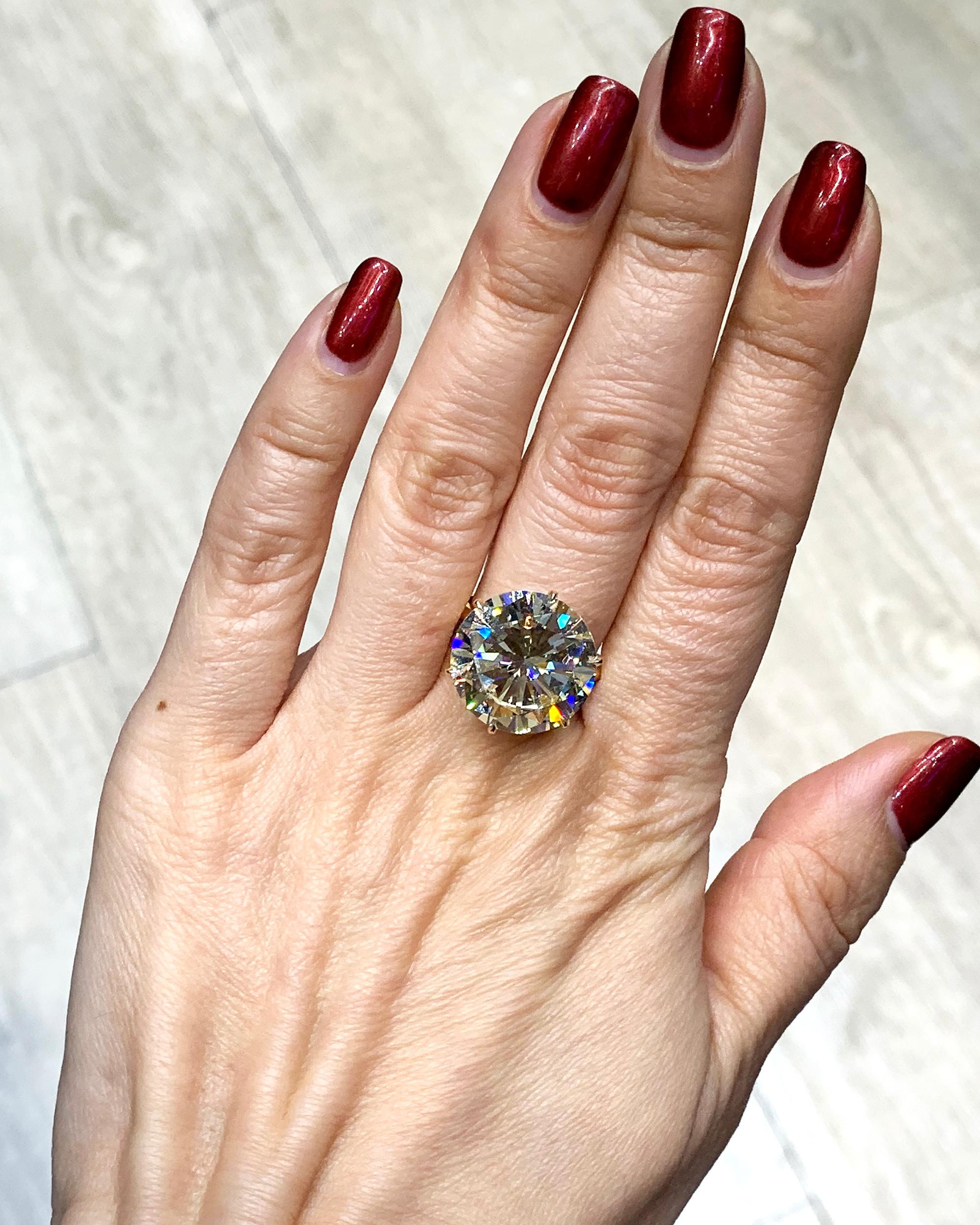 Behold the epitome of timeless elegance with this exquisite solitaire ring, a testament to refined luxury and understated glamour. Gracefully adorned with a captivating 14.50 carat natural round diamond, cradled in the warmth of 18K yellow gold,