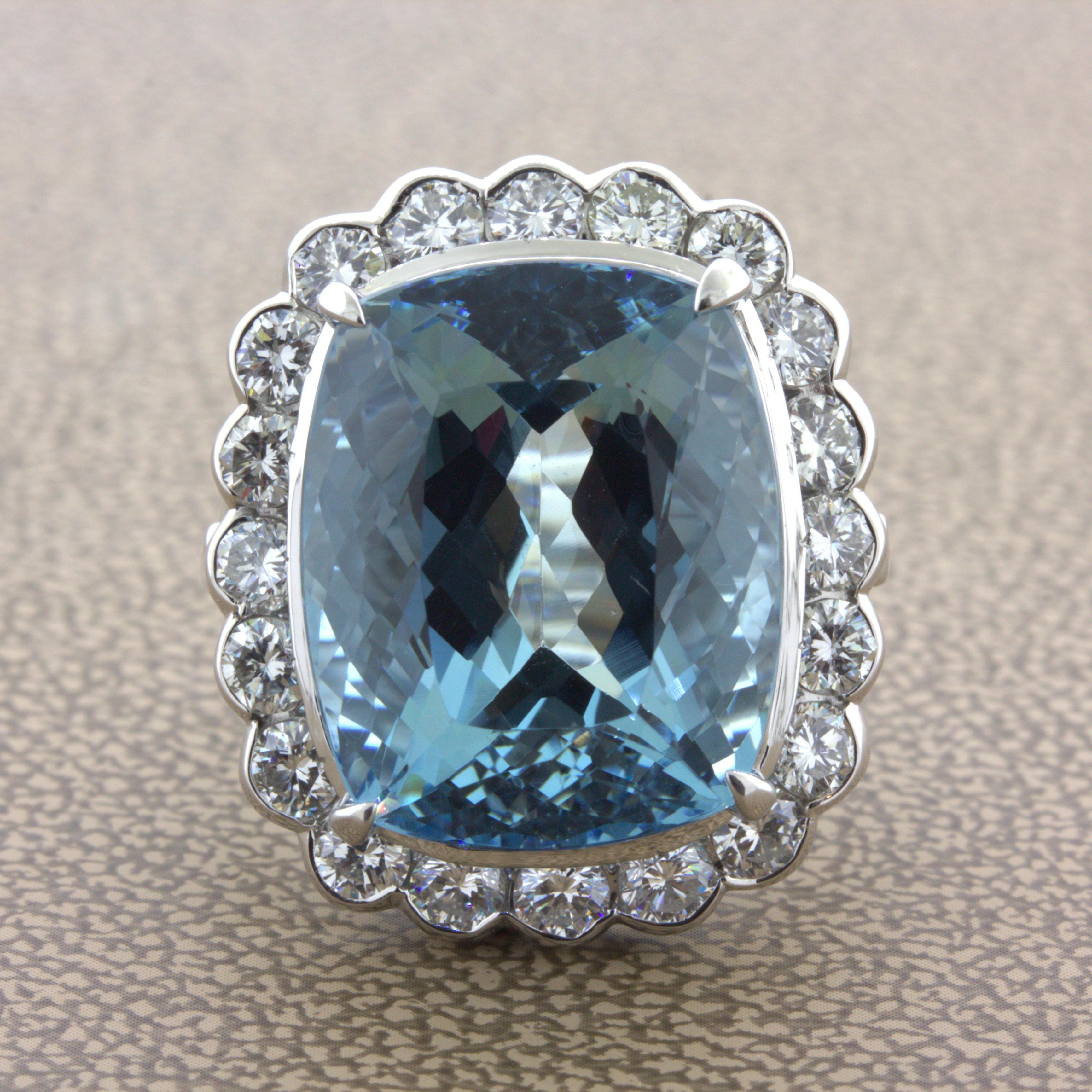 A lovely cocktail ring featuring a very fine cushion shape aquamarine. What makes this aqua special is the combination of its large size, 14.51 carats, rich sea-blue color, and its eye-clean clarity. The stone shines bright and brilliant with