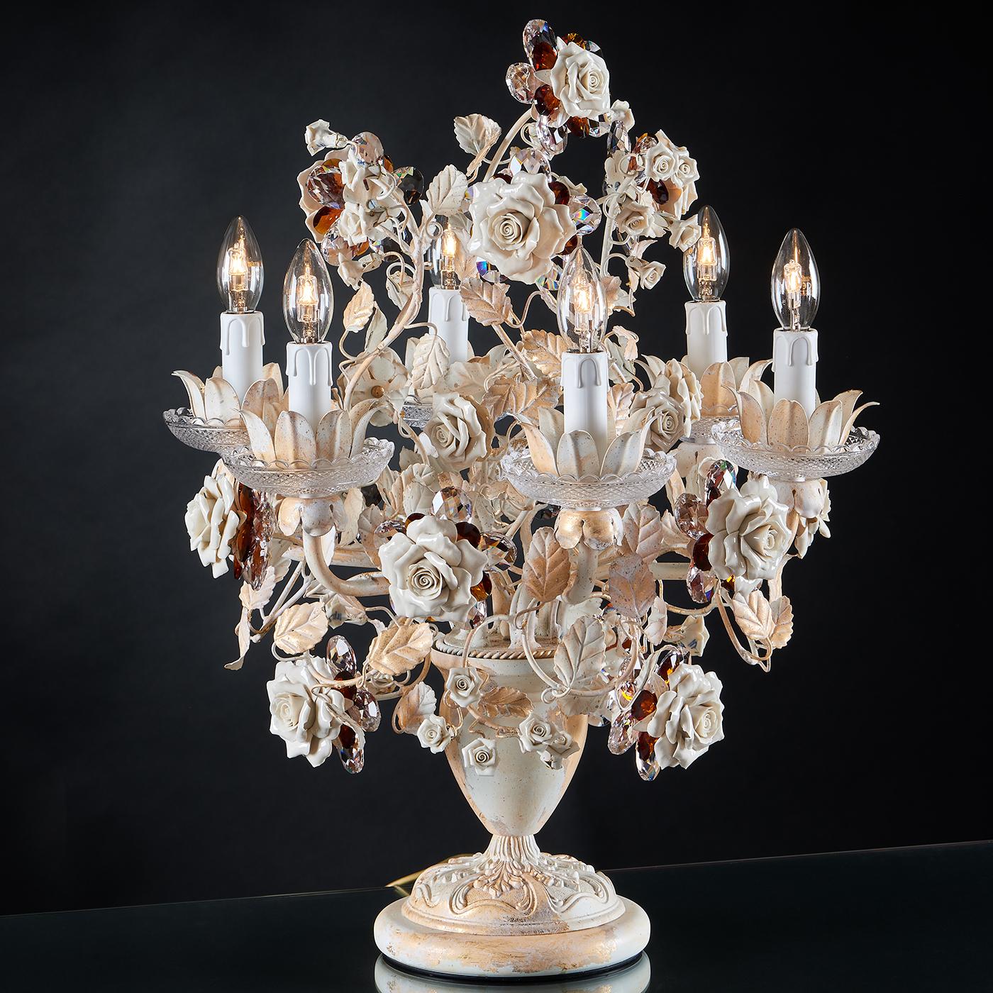A table lamp in white hand-decorated metal with gold leaf inserts, two-tone crystal ornaments, and roses entirely made in Capodimonte porcelain. It is an extremely detailed piece, and combined with the fact that this piece is unique and it can't be