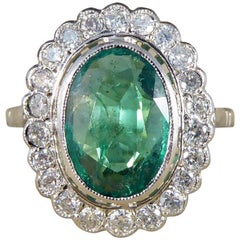 Vintage 1.45 Carat Emerald and Diamond Halo Cluster Ring in Platinum