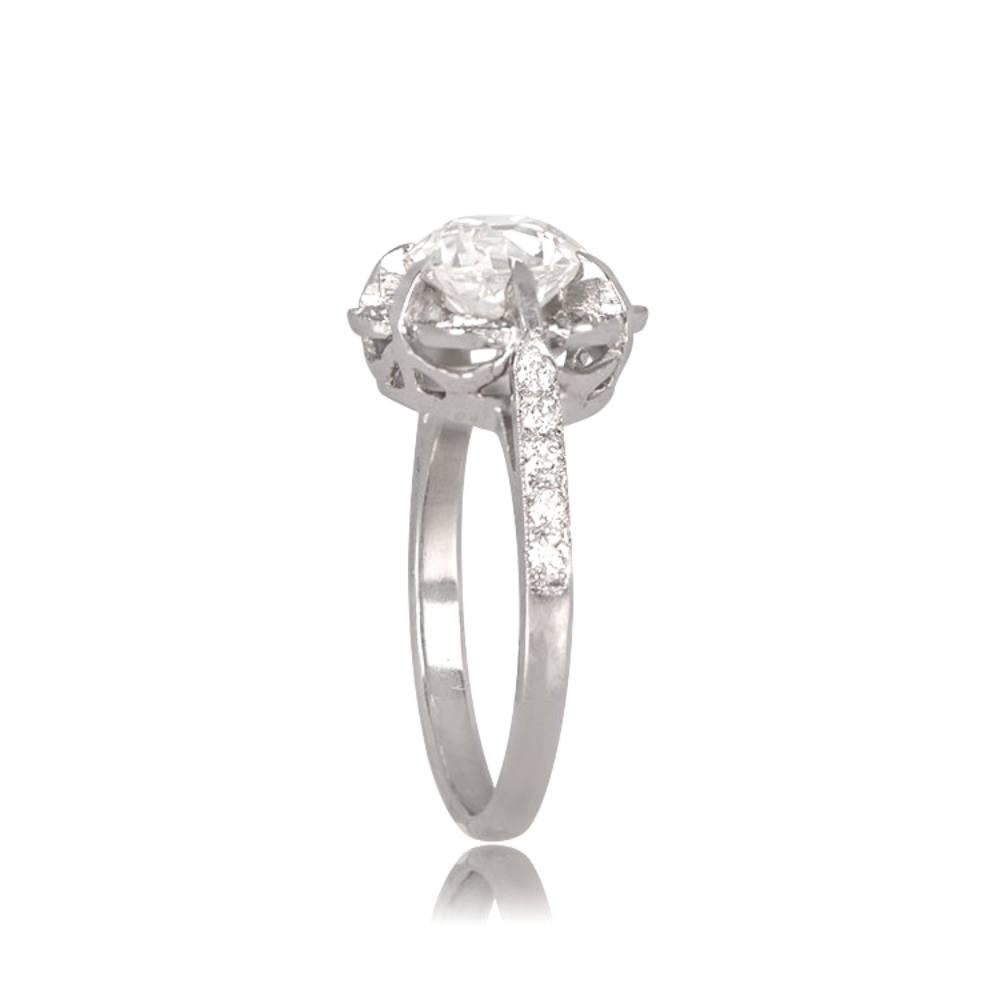 This hand-crafted platinum ring boasts a beautiful floral motif design with a dazzling old European cut diamond at its center, weighing around 1.45 carats. The center stone is prong set and surrounded by a cluster of old European cut diamonds, with
