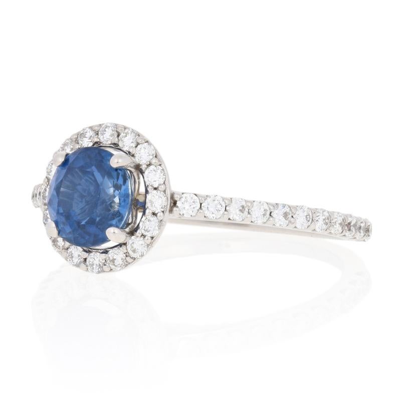 Surprise your princess with the ring of her dreams! Featuring a gorgeous halo design, this engagement piece showcases a silky blue sapphire accompanied by sparkling diamonds set in 14k white gold.  

This ring is a size 5, but it can be re-sized up