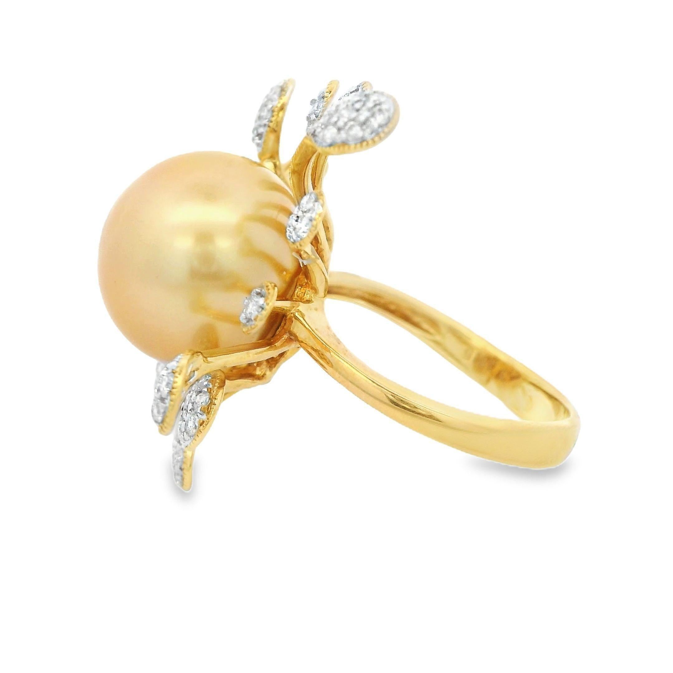 This extraordinary ring features a stunning 13.1mm golden South Sea pearl, celebrated for its exceptional luster and rich, warm hue. The pearl is the focal point, surrounded by a radiating design of 0.49 carats of sparkling diamonds. These diamonds
