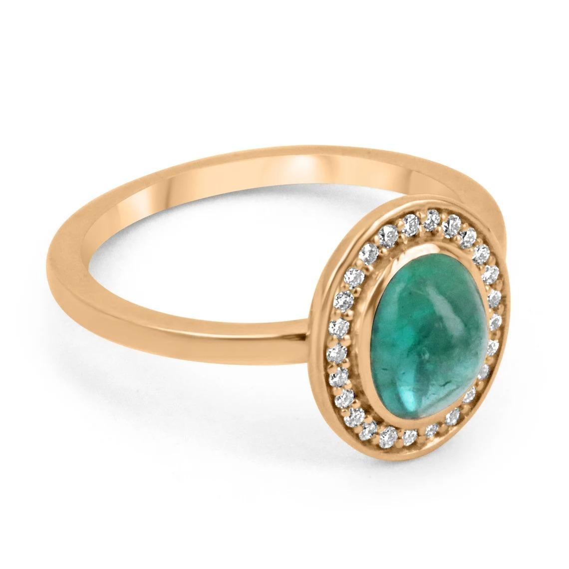 A beautiful, emerald cabochon and diamond accent ring. The center gemstone features a lovely 1.30-carat, natural emerald cabochon cut in an oval shape. Carefully bezel set, with pave set diamonds creating a gorgeous halo. Crafted in gleaming 14K