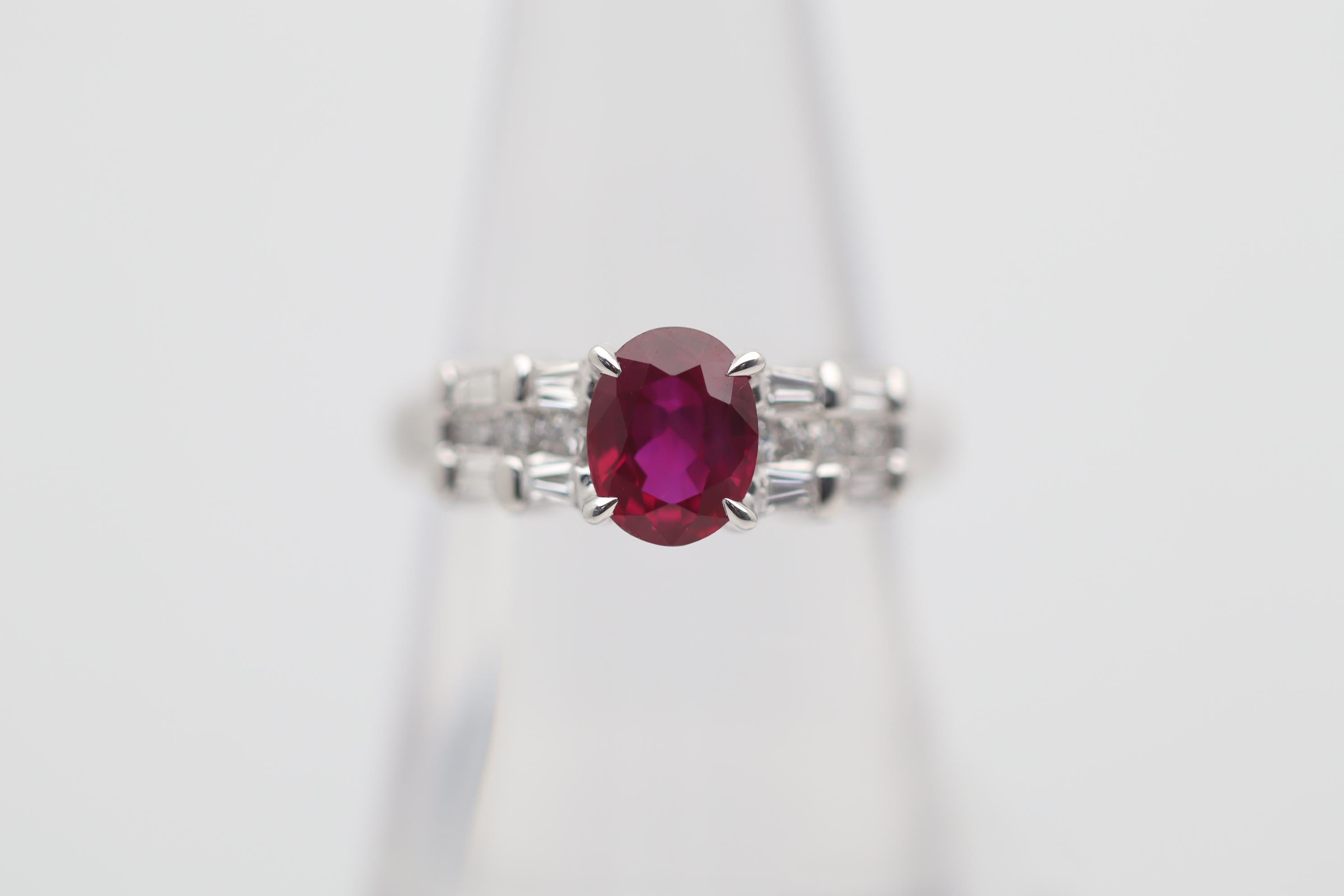 A lovely ring featuring a fine Burmese ruby weighing 1.46 carats. It has a rich vibrant red color and is certified from the GIA as natural with a Burmese origin. It is complemented by 0.43 carats of round brilliant and baguette-cut diamonds set on