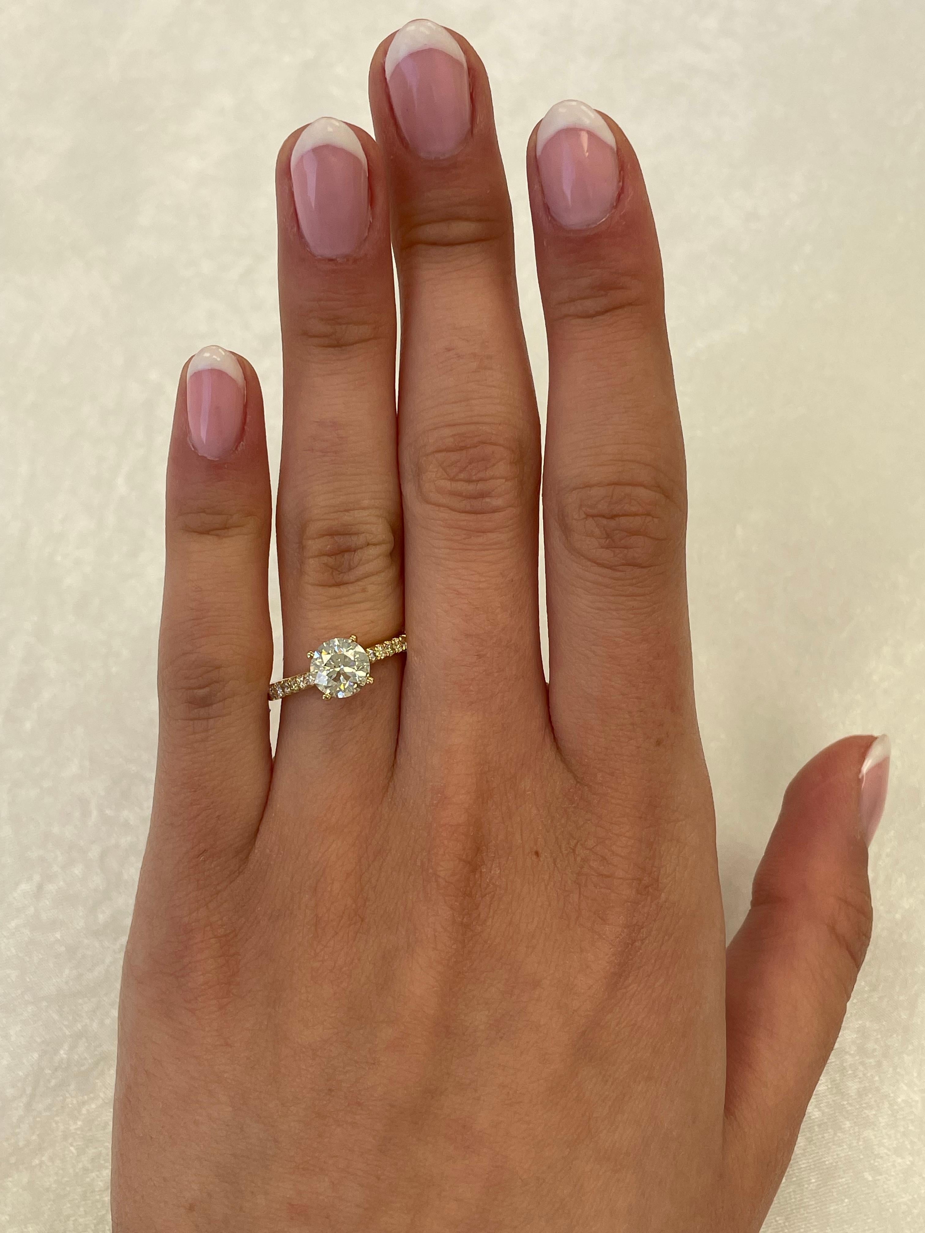 Classic solitaire diamond engagement ring with diamonds down the shank.
1.83 carats total diamond weight.
1.46 carat round brilliant diamond, approximately J color grade and SI2/I1 clarity grade. Complimented by 0.37 carats of round brilliant