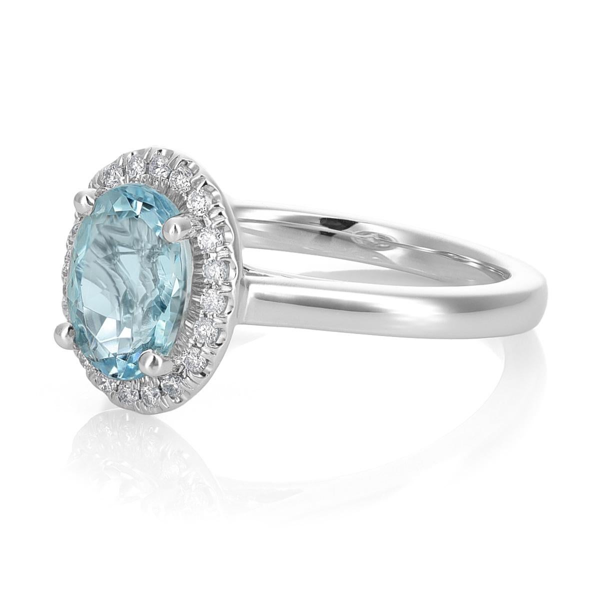 Presenting a captivating Natural Aquamarine, elegantly set in a 14K White Gold Ring adorned with 0.10 carats of Diamonds. The gem, in a graceful oval shape, exudes a serene beauty, accentuated by its subtle blue hue. This enchanting piece, with a