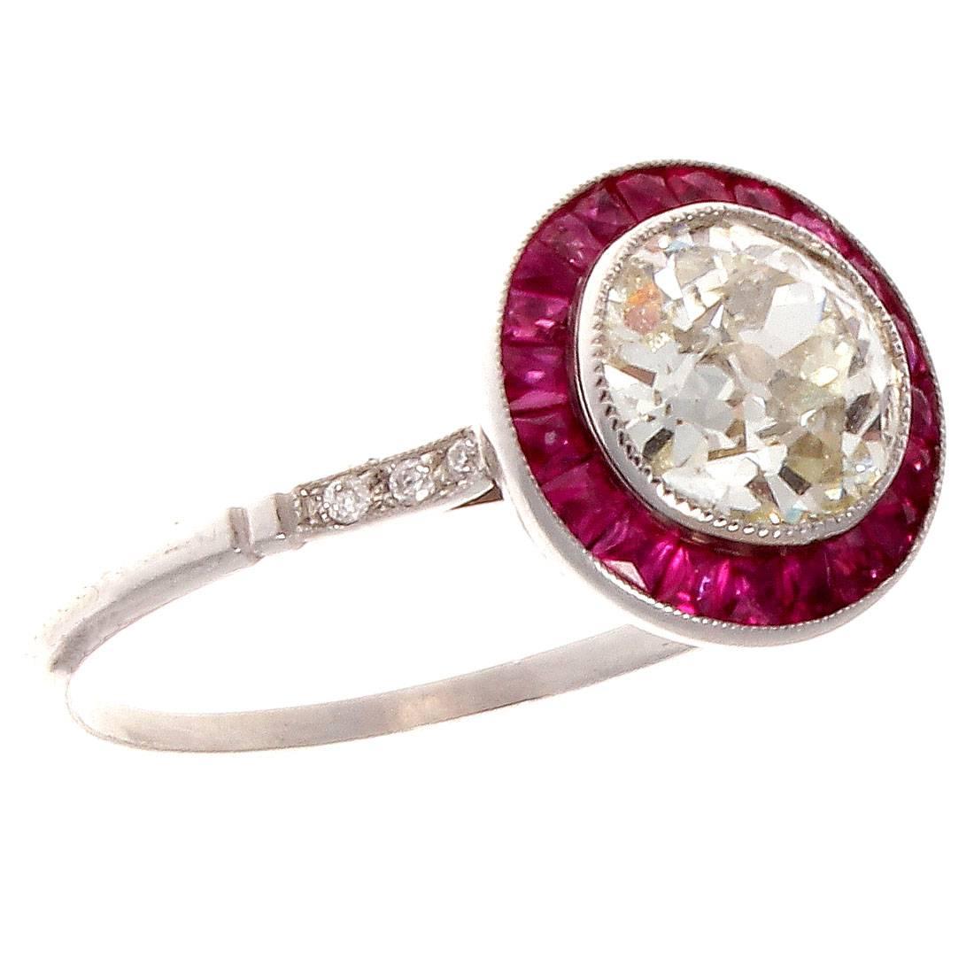 The 19th century creation that never goes out of style. This halo engagement ring features a 1.46 carat old European cut diamond that is L color, SI1 clarity perfectly surrounded by a halo of vibrant red rubies. Hand crafted in platinum.

Ring size