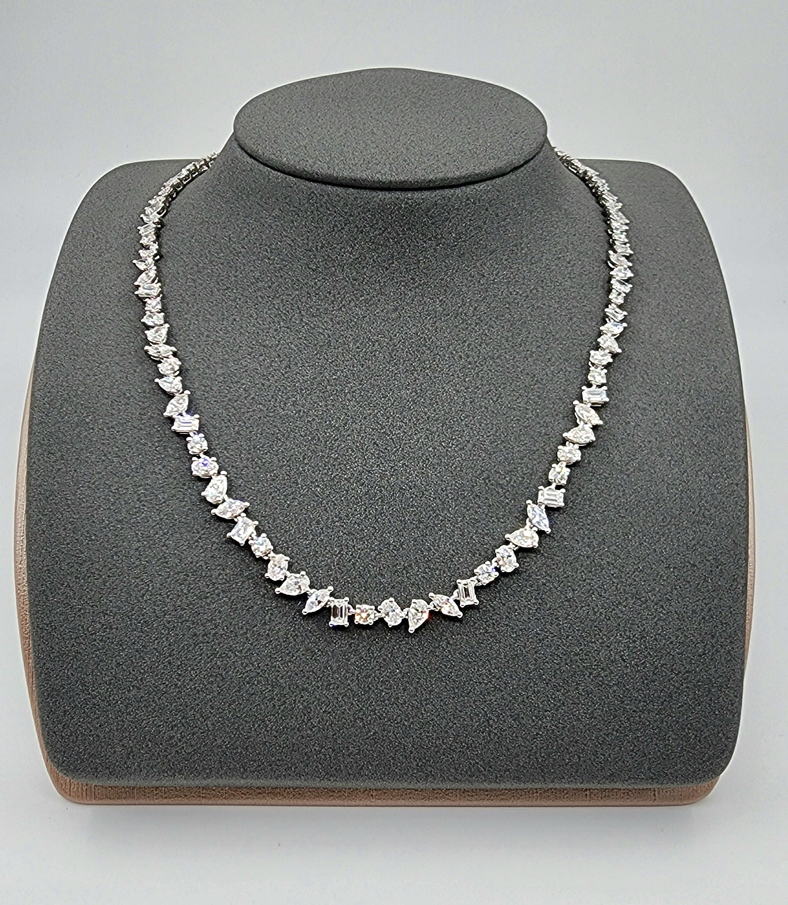 This tennis necklace features mixed-cut white diamonds with a total carat weight of 14.61. The diamonds are E/F in color and VS1/VS2 in clarity. Crafted in platinum, the necklace measures 16.5 inches in length. Made in the USA, this modern piece is