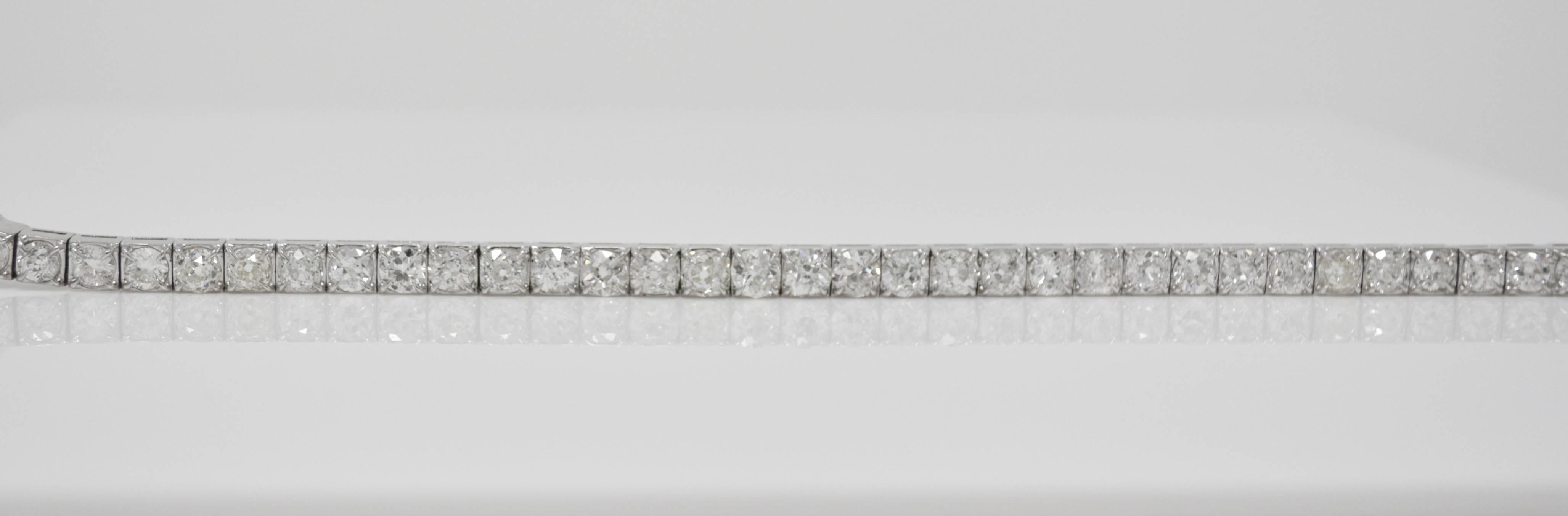 This gorgeous bracelet is designed as an antique style flexible band of thirty three graduated old mine brilliant diamonds weighing 14.67carats ( 0.45 carat each )  with HI color and VS SI clarity , 7 inches , hand crafted in platinum.