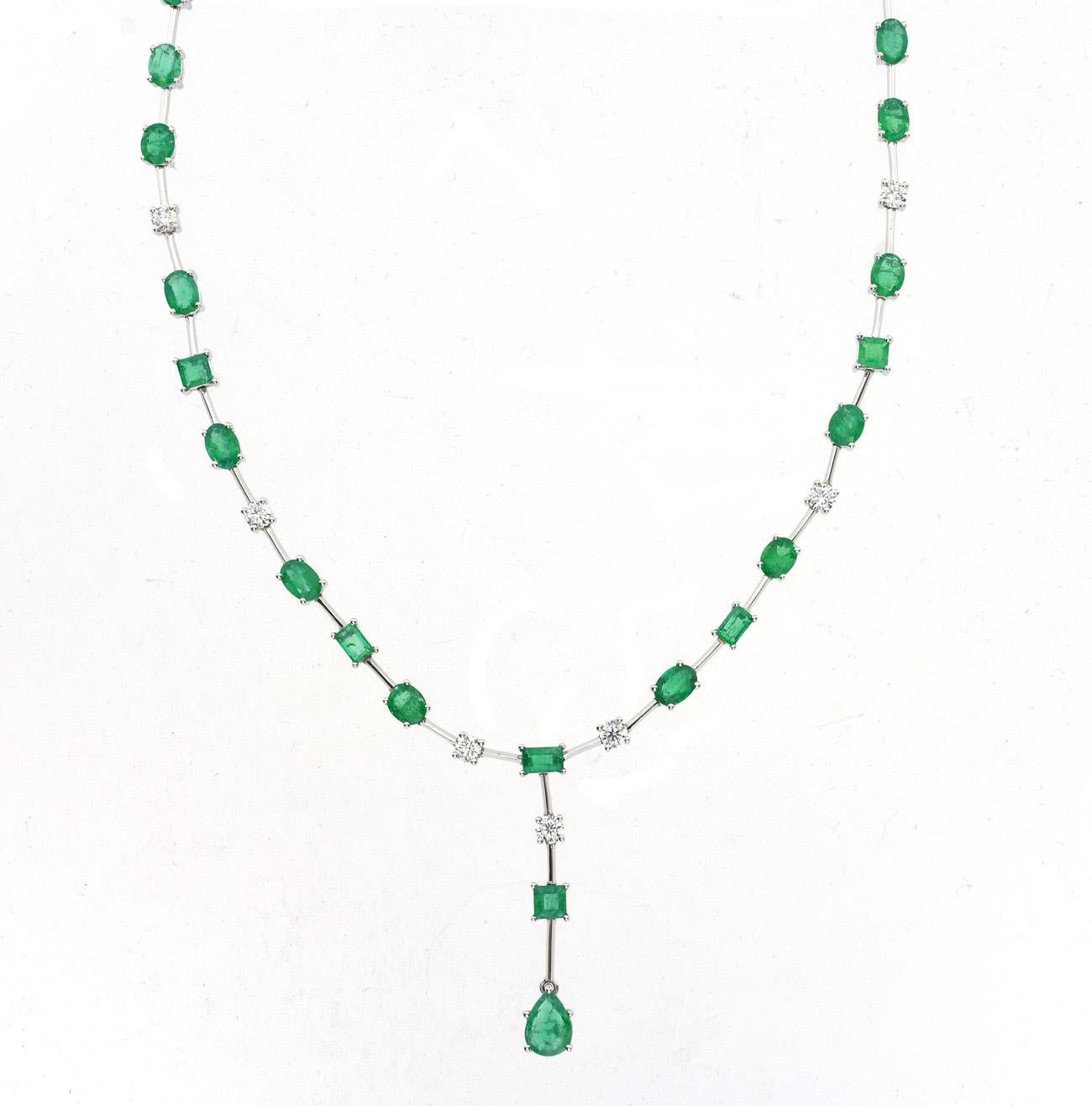 The showstopping 14.67 carat emerald and white diamond drop necklace is perfect for any occasion. This 18k white gold necklace features 2.29 carat white diamonds and 12.38 carat emeralds. The white diamonds are round cut, while the emeralds are