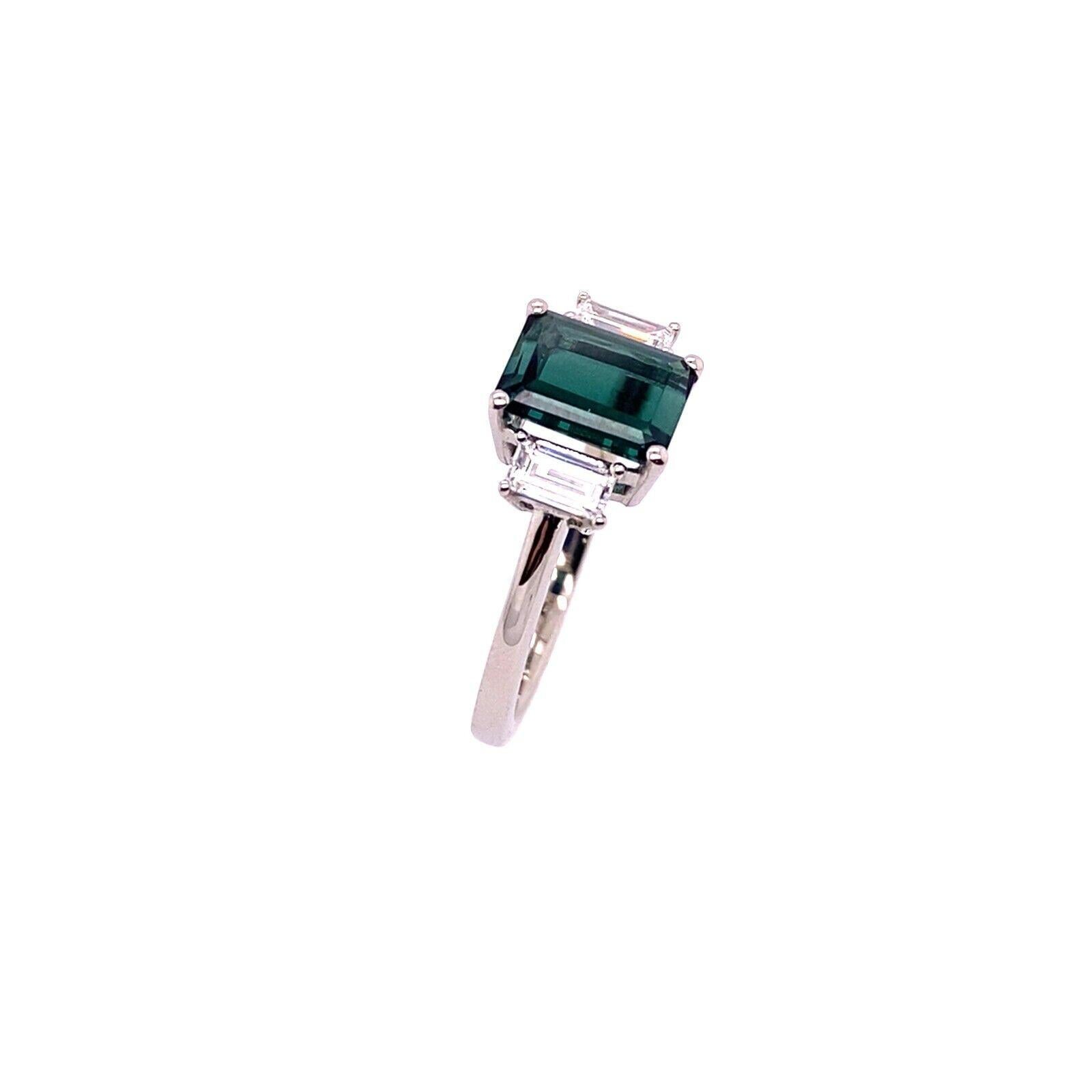1.46ct Emerald Cut Green Tourmaline With Matching Baguette Diamonds 3-Stone Ring
This elegant 3-stone ring features an 1.46ct Emerald cut green Tourmaline centre stone, with 2 matching baguette Diamonds on each side, 0.36ct in total. Set in a