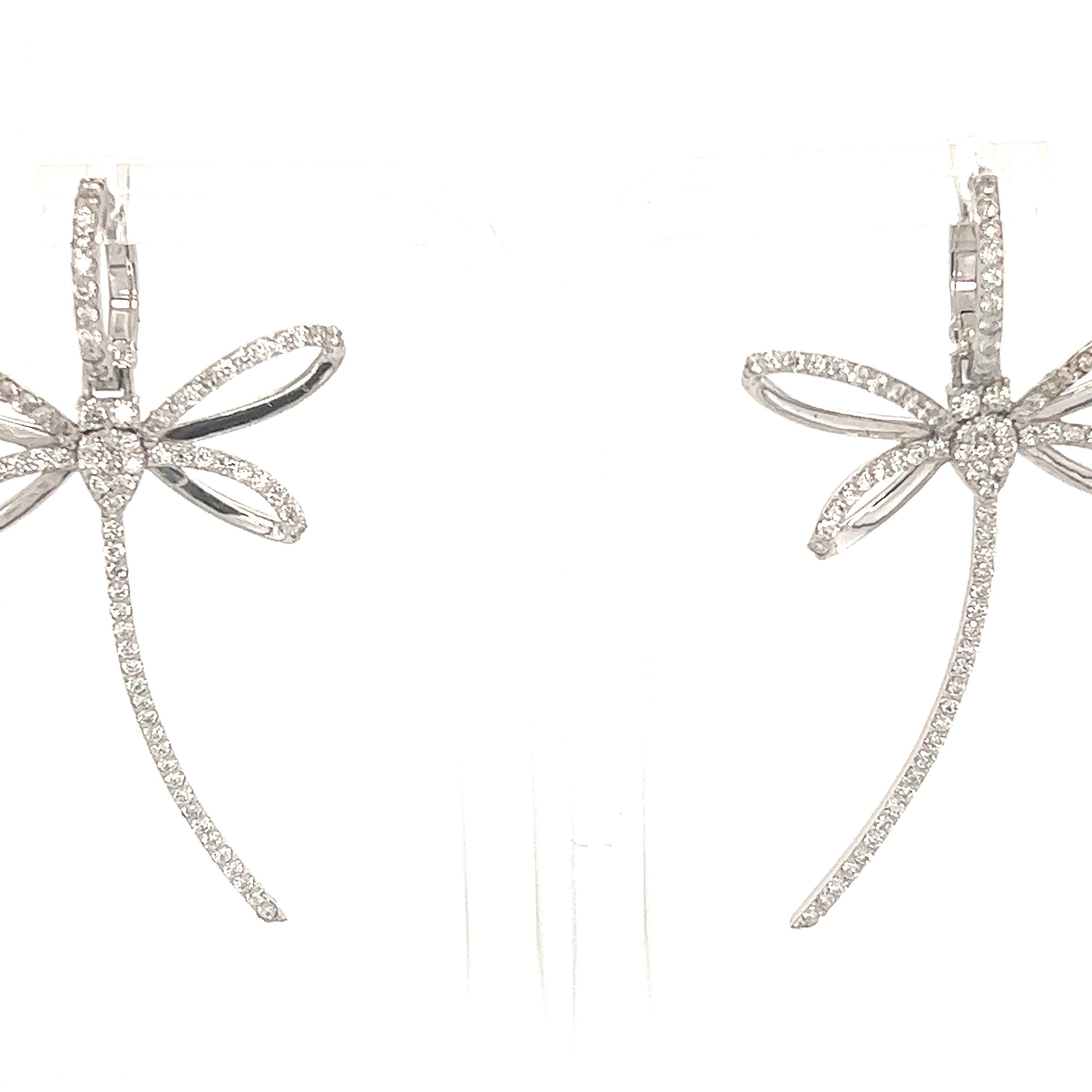 These earrings have Natural Round Cut White Diamonds that weigh 1.47 carats. The clarity and color of the earrings are VS-F. 

They are 2 inches long and are curated in 14 Karat White Gold with an approximate weight of 6.3 grams. 

