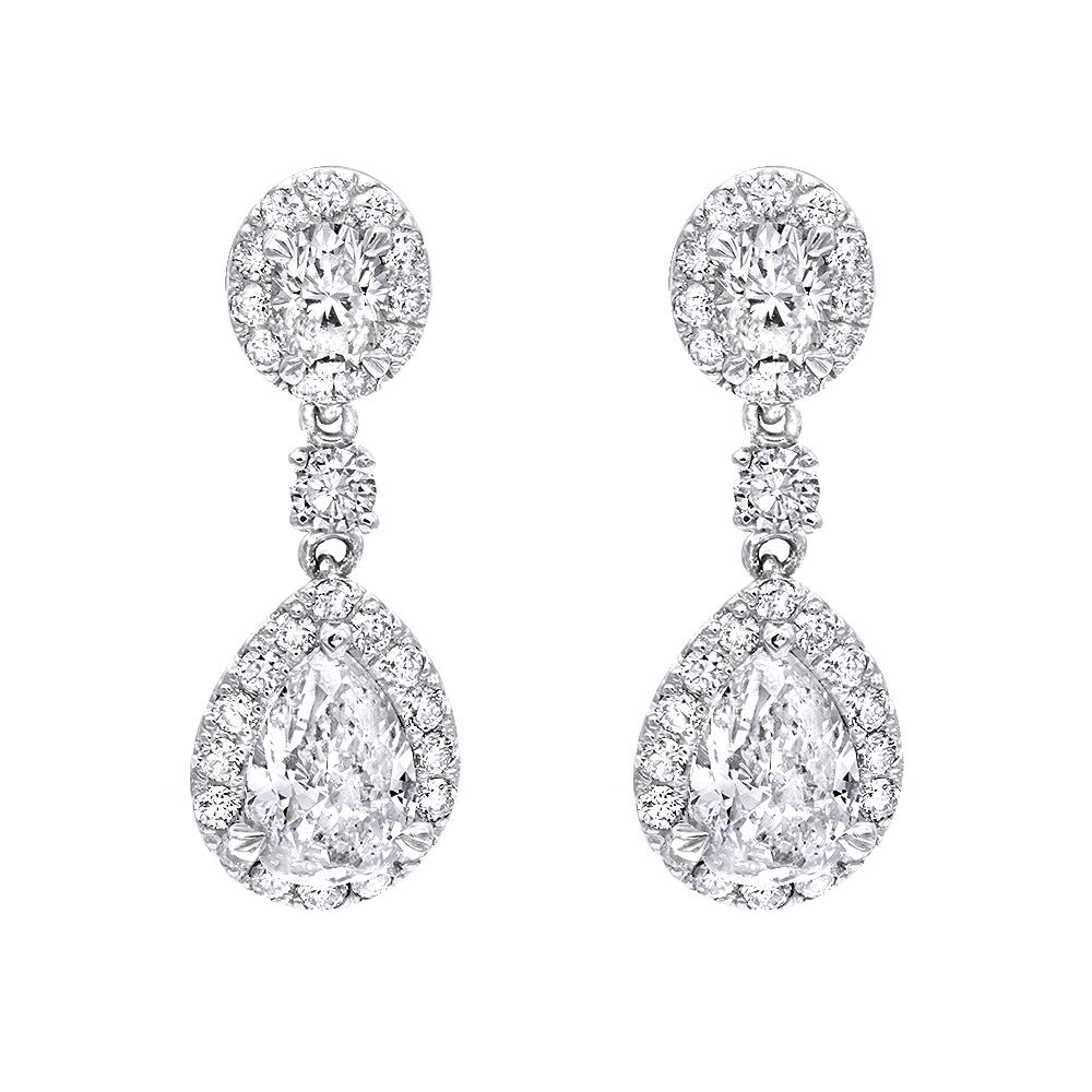 Ladies elegant diamond drop  dangle earrings.
2 pear shaped diamonds 1.47 carat TW
Surrounded by 0.85 carat round brilliant diamonds SI1 clarity F\G color.
2 oval shaped diamonds 0.44 carat.
Earrings are mounted in 14k white gold.
The diamonds are