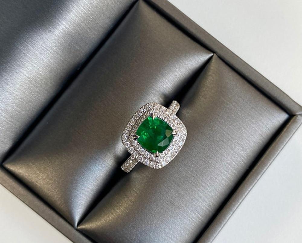 Emerald Weight: 1.47 CTS, Measurements: 6.7 x 7.2 mm, Diamond Weight: 0.58 CT, Metal: 18K White Gold, Ring Size: 6.5, Shape: Cushion, Color: Green, Hardness: 7.5-8, Birthstone: May