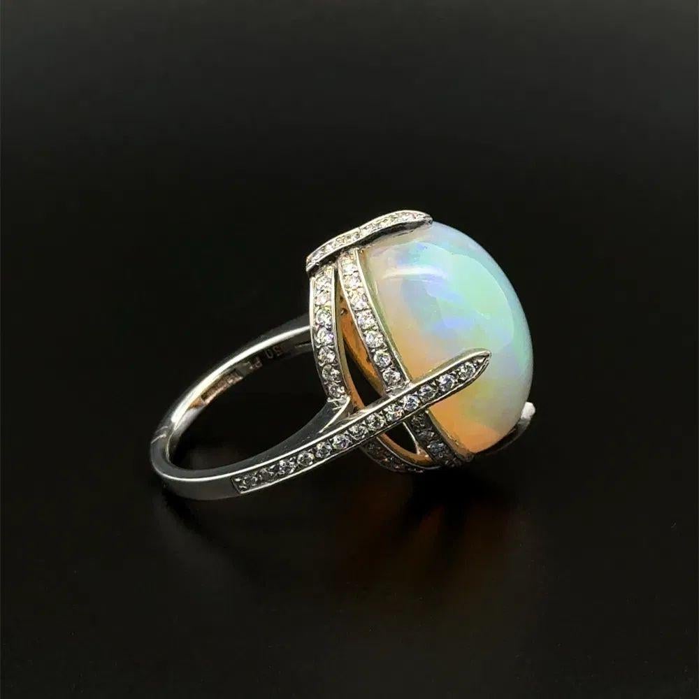 Simply Beautiful! Elegant and Finely detailed Vintage Solitaire Ring, centering a securely nestled Hand set 14.72 Carat Crystal Opal. Enhanced by Hand set Round Brilliant Cut Diamonds, weighing approx. 1.40tcw. Exquisitely Hand-crafted Platinum