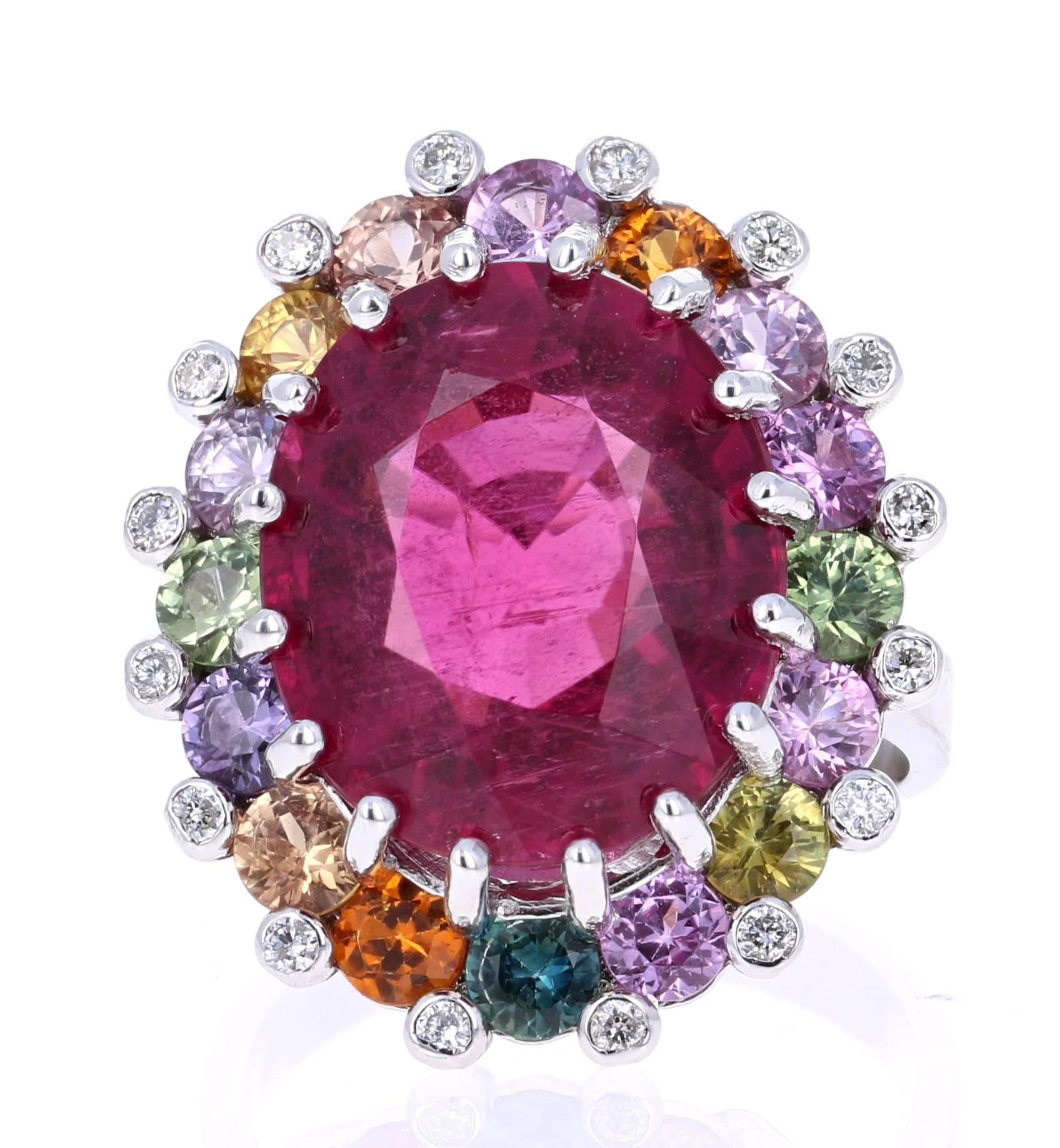 Super gorgeous and uniquely designed 14.73 Carat Pink Tourmaline and Multi-Colored Sapphire Diamond 18K White Gold Cocktail Ring!

This ring has a 11.47 carat Oval Cut Pink Tourmaline that is set in the center of the ring and is surrounded by 16