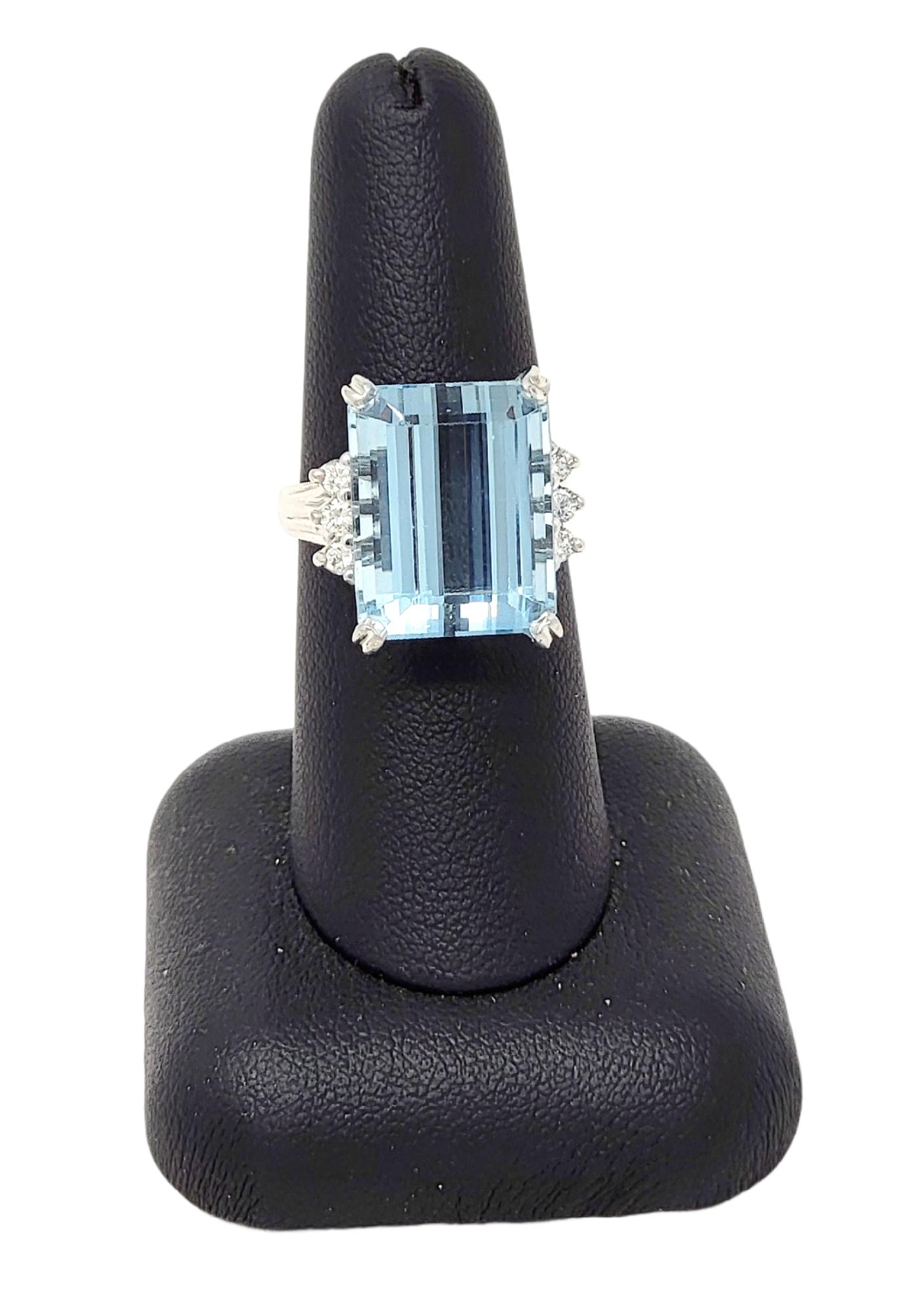 Ring size: 7.25

Breathtaking aquamarine and diamond cocktail ring. This eye-catching piece makes a bold statement with both its impressive size and exquisite color. The incredible 14.53 carat emerald cut aquamarine stone is 4 prong set in 18 karat