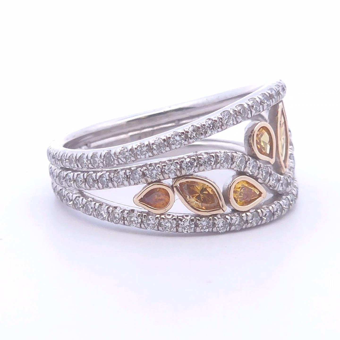 This exquisite 1.47ct Two-Tone Fancy Diamond Ring is a stunning piece crafted in 14K gold, combining elegance with modern design. The ring features a captivating central fancy diamond, encased in a warm yellow gold bezel that accentuates its unique
