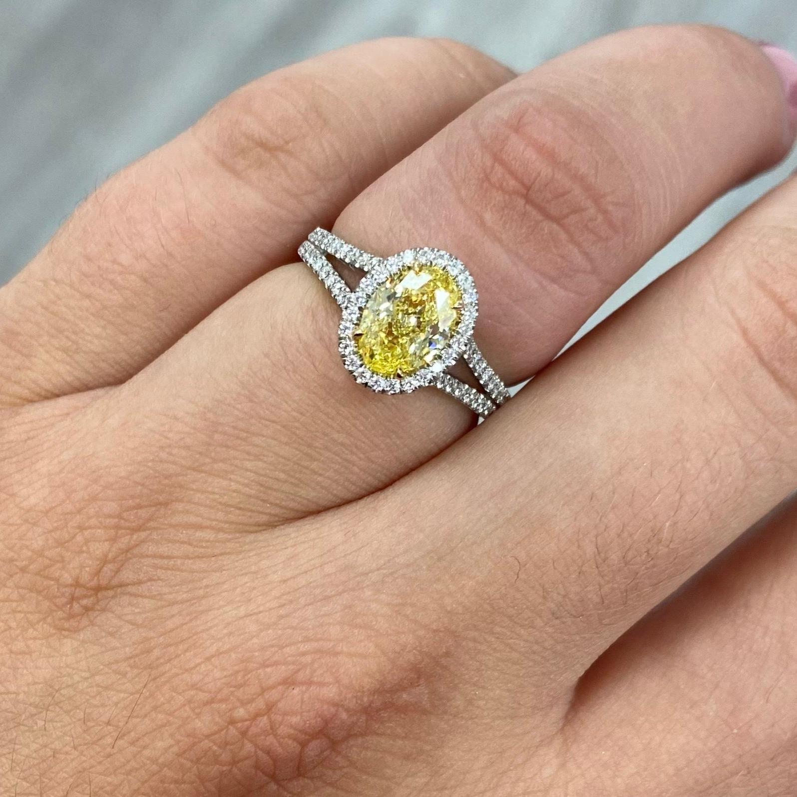 Elegant ring with a strong Fancy Intense Yellow Oval in a gorgeous split shank halo design
1.47 Carat GIA Fancy Intense Yellow Oval 
SI1 Clarity 
Designed with a micro pave halo & split shank 
Surrounded with 0.36 Carats of White Diamonds
Handmade