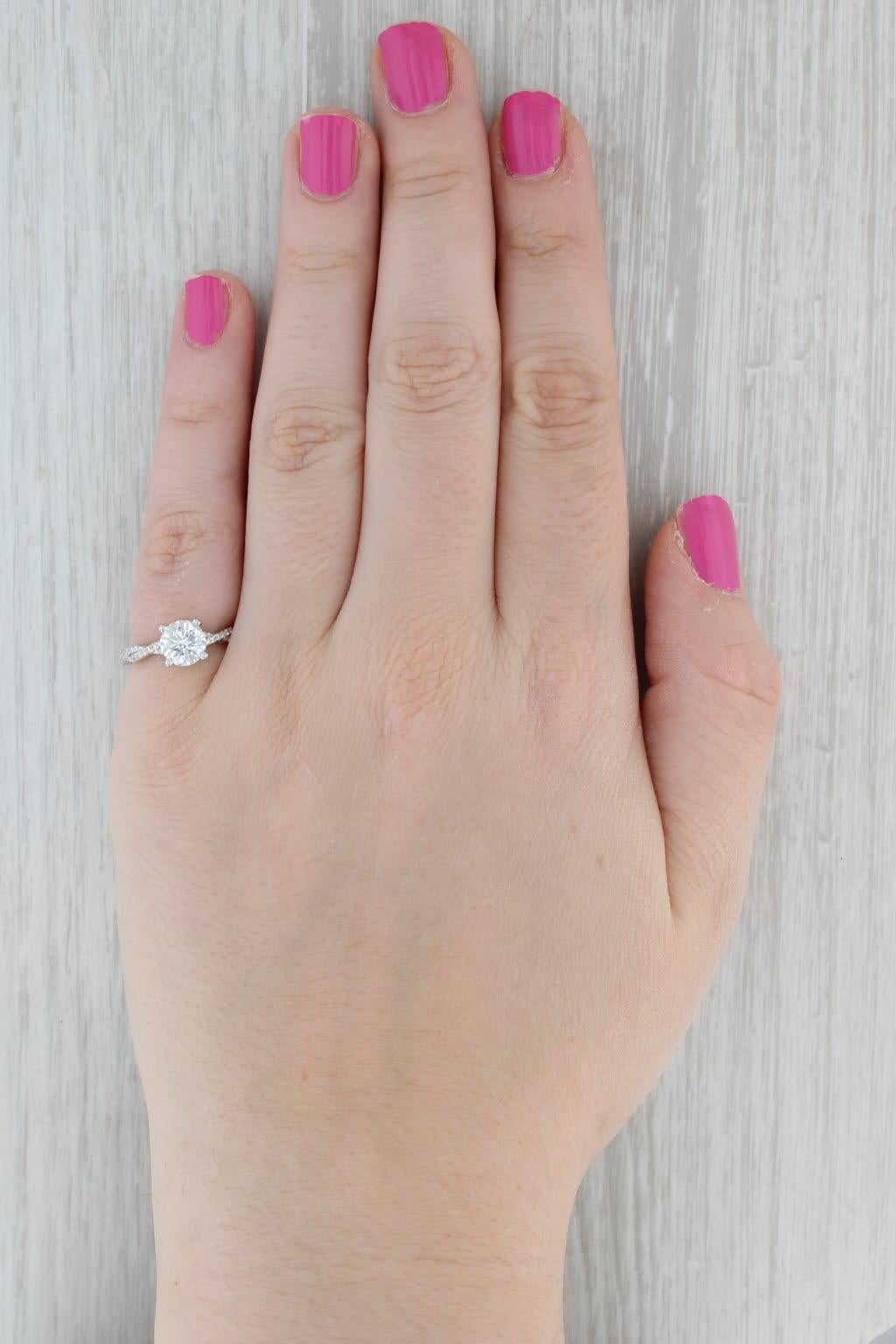 Gemstone Information:
- Natural Diamond -
Carats - 1.23ct 
Cut - Round Brilliant
Color - G - H
Clarity - I1 
The girdle is laser engraved S0629.

- Natural Diamonds -
Total Carats - 0.24ctw 
Cut - Round Brilliant
Color - H - J
Clarity - VS2

Metal: