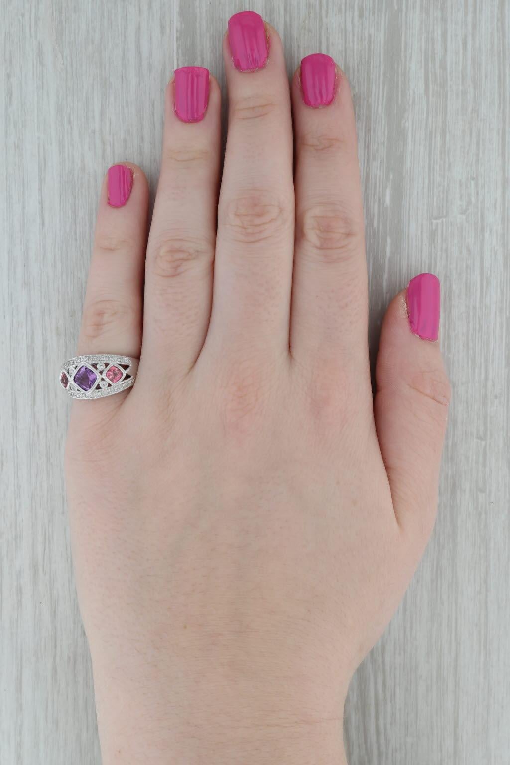 Gemstone Information:
- Natural Amethyst -
Carats - 0.80ct
Cut - Cushion Brilliant
Color - Purple

- Natural Tourmalines -
Total Carats - 0.60ctw
Cut - Cushion Brilliant
Color - Pink 

- Natural Diamonds -
Total Carats - 0.07ctw
Cut - Round
