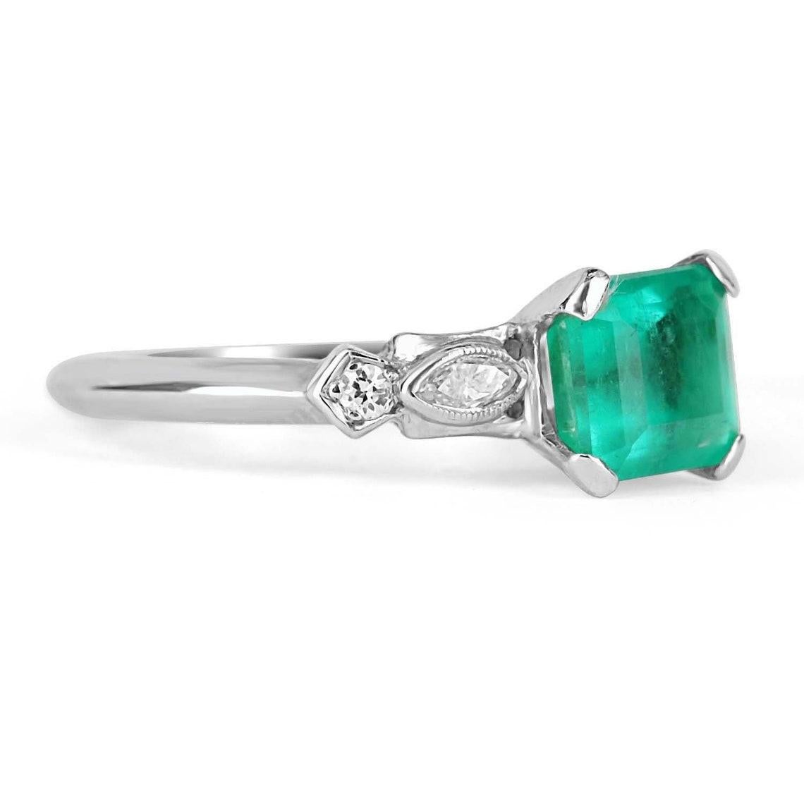 Elegantly displayed is a natural, emerald cut Colombian emerald and diamond accent engagement ring. The center gem is a fine quality, emerald cut, emerald filled with life and brilliance! Among the emeralds, impressive qualities are its vibrant