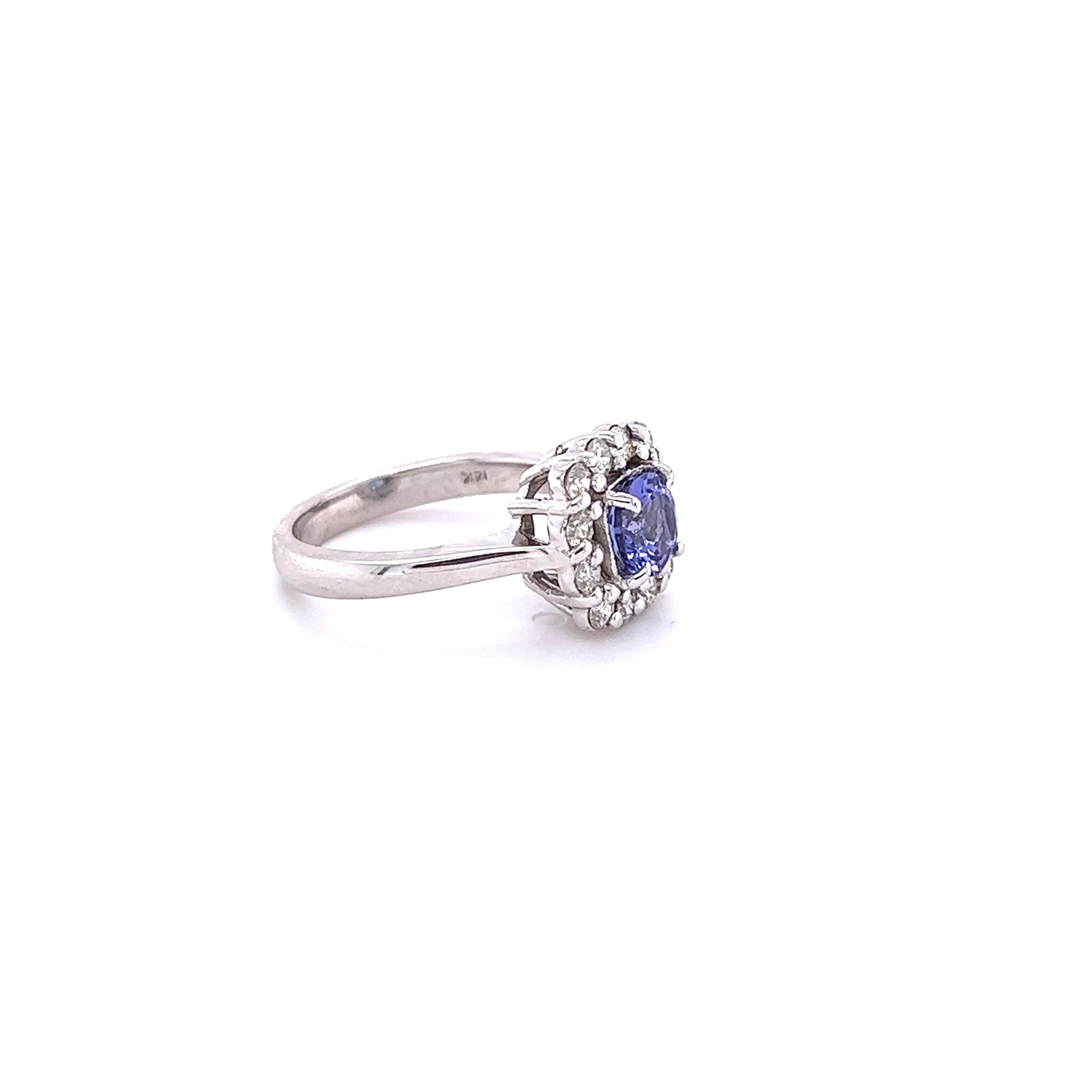 
This ring has a Round Cut Natural Blue Sapphire that weighs 1.01 Carats. It measures at 6 mm and has a purplish blue hue to it.

It is embellished with 12 Round Cut Diamonds that weigh 0.47 Carats. The clarity and color of the diamonds are VS-H.