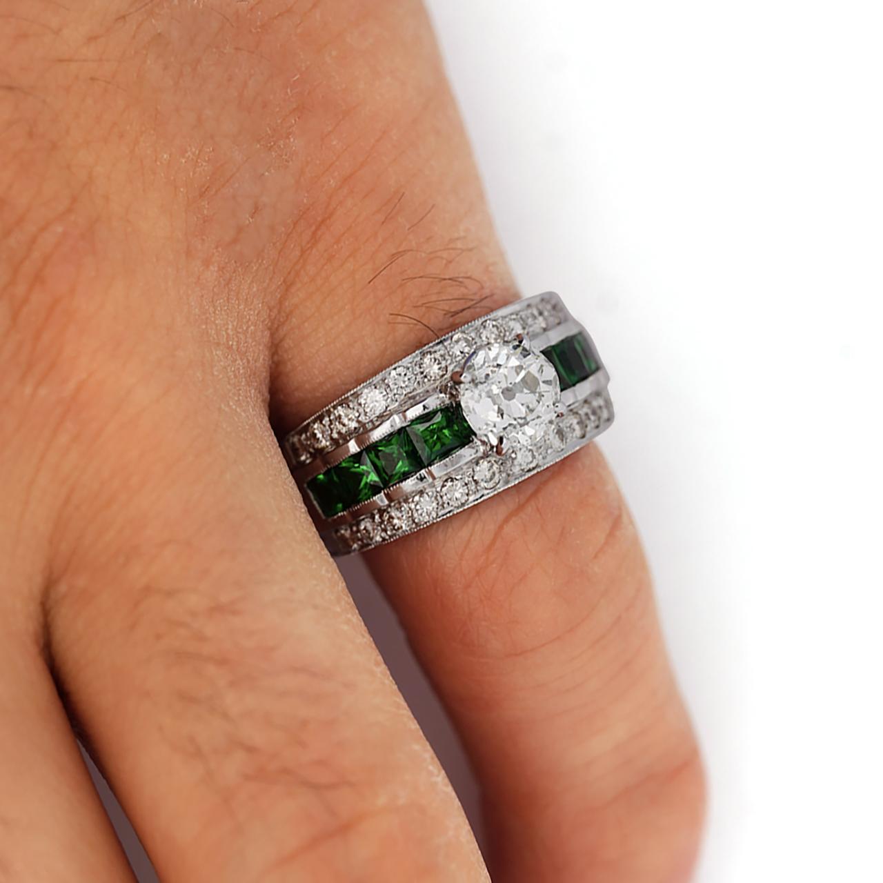 Vintage 1.48 carat old cut diamond in 18K white gold Art Deco-inspired setting featuring princess cut tsavorite garnet accents and pave diamonds. Hand-crafted filigree work with milgrain detailing.

Ring size 8 adjustable, weighing 12.64