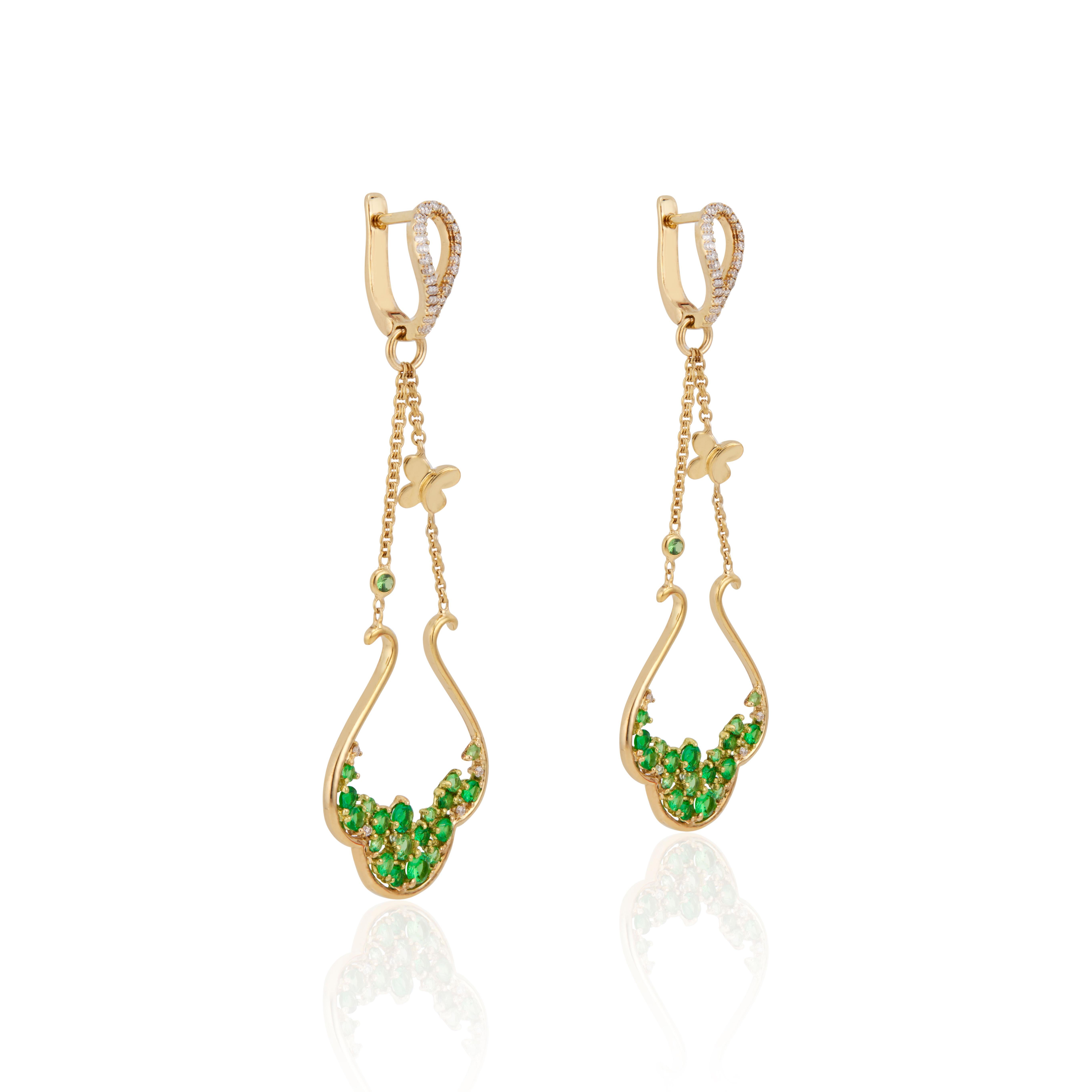 Tsavorite and diamond dangle earrings. 38 round green Tsavorite garnets with 58 round accent diamonds in 14k yellow gold dangle chandelier earrings.  

38 round green Tsavorite Garnets, approx. total weight 1.29cts
58 round diamonds, approx. total