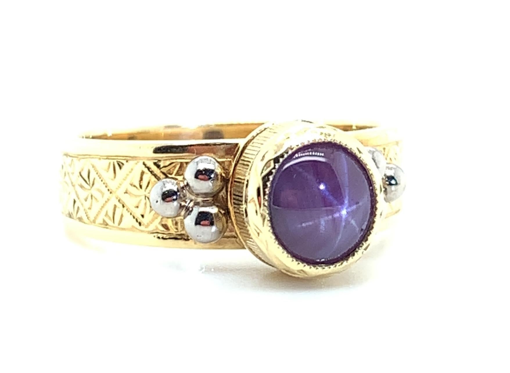 1.48 Ct. Bezel Set Star Ruby Cabochon, Yellow & White Gold Engraved Band Ring In New Condition In Los Angeles, CA