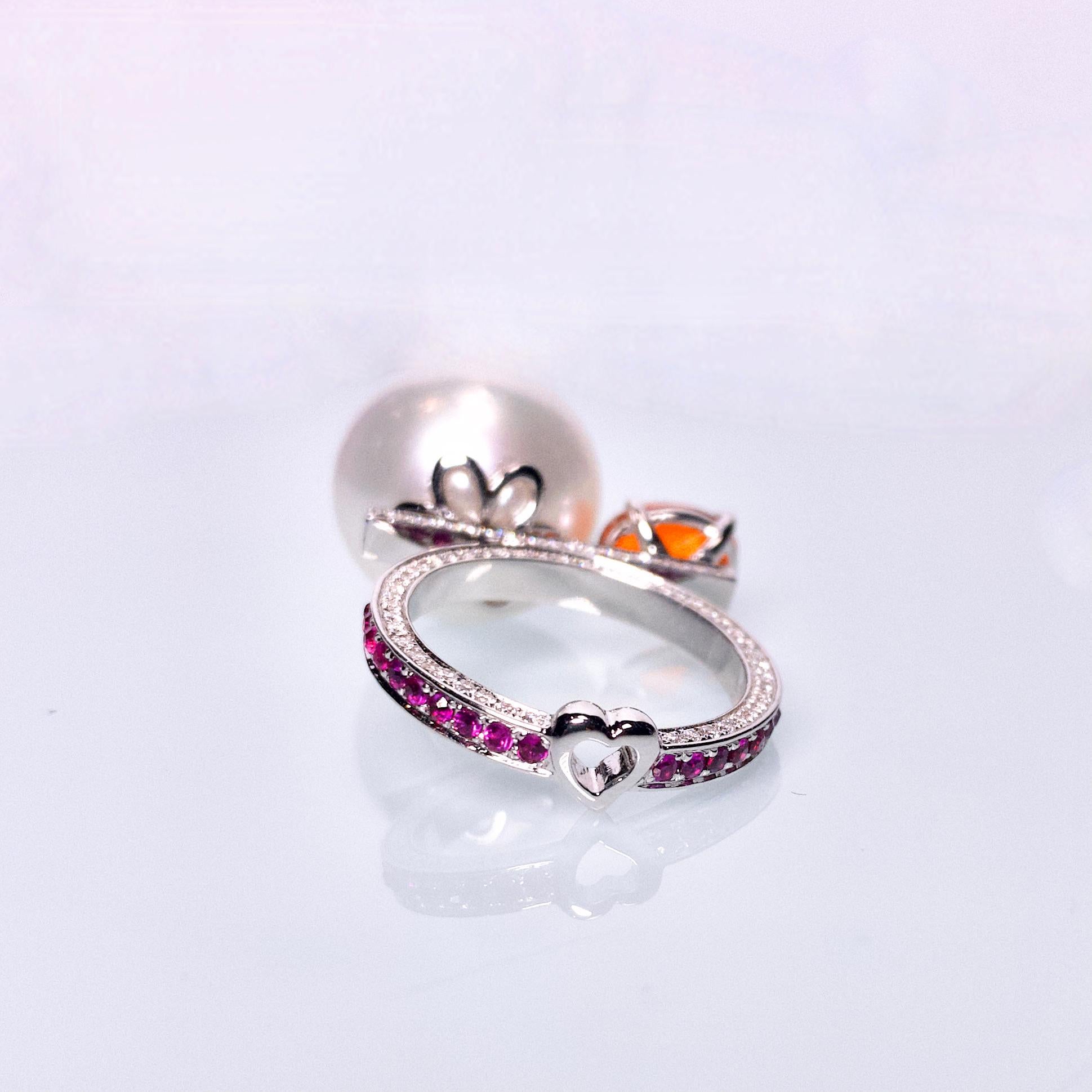 It is a very bold design with pearls and Fire Opal sitting at two ends of a scale. The surface of the ring is full of Diamonds and Rubies pave except for the claws. It is a big and unique cocktail ring and would suit those who love a big loud ring.