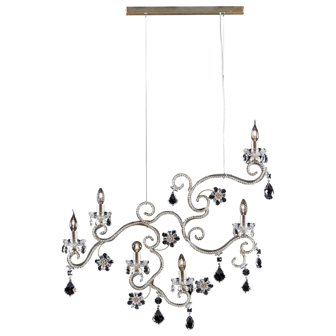 This is a metal suspension lamp characterized by a multitude of deluxe decorations. The structure is embellished with antiqued-silver coating and rows of polished beads, with flowers and pendants in Asfour crystal to top it off. It will give a