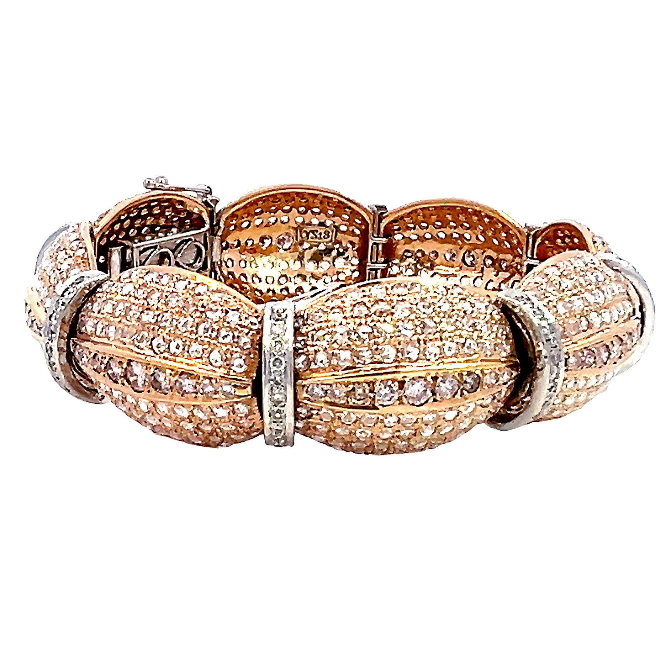 This exquisite 18K rose gold and white gold diamond modern link tennis bracelet showcases 14.80 carats of round brilliant pink and white diamonds in an elegant alternating link design. Each oval-shaped 18K rose gold link is adorned with pavé-set