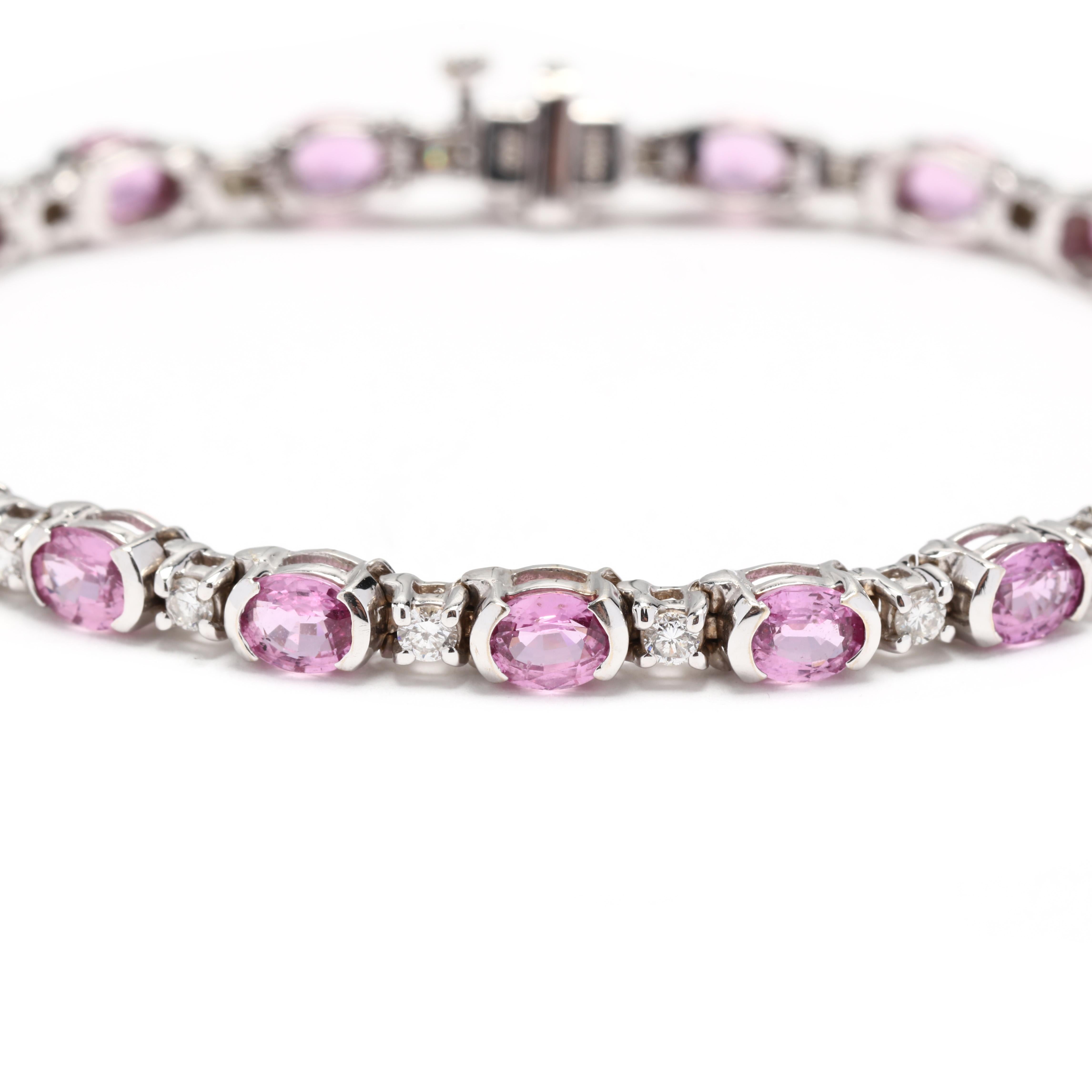 A vintage 18 karat white gold pink sapphire and diamond tennis bracelet. This stackable bracelet features alternating half bezel set, oval cut pink sapphires weighing approximately 14 total carats and prong set, round brilliant cut diamonds weighing