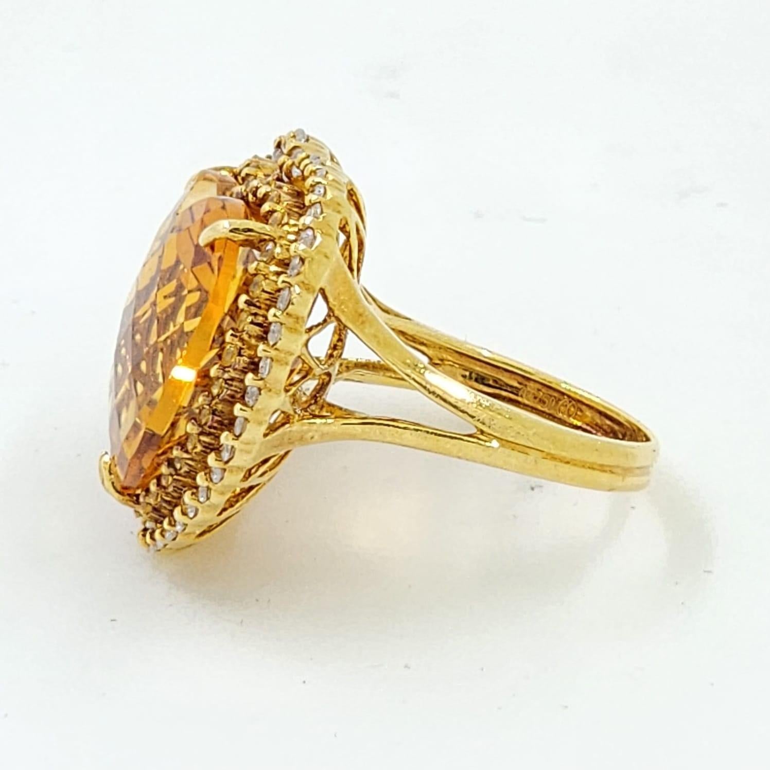 This stunning cocktail ring is a true statement of luxury and elegance. Crafted meticulously in 18 karat yellow gold, the ring is centered by a magnificent heart-cut citrine weighing 14.81 carats. This citrine is a gem of warmth and vibrancy, its