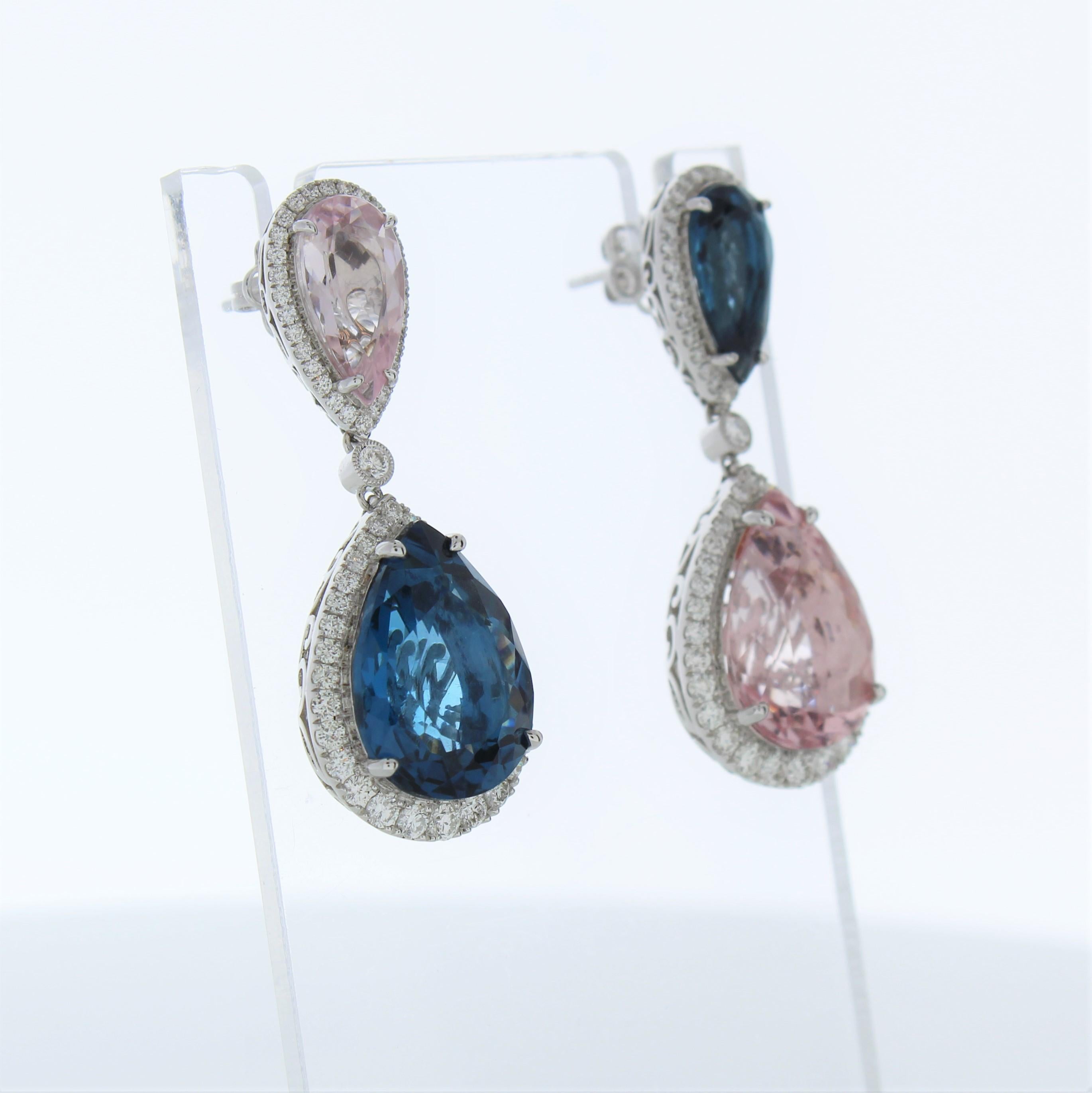 The fashion earrings feature two pear-cut blue topaz gemstones, each weighing a total of 14.82 carats, set in 14 karat white gold. They are further accented by a total of 244 round-cut diamonds with a combined weight of 1.57 carats in both earrings.