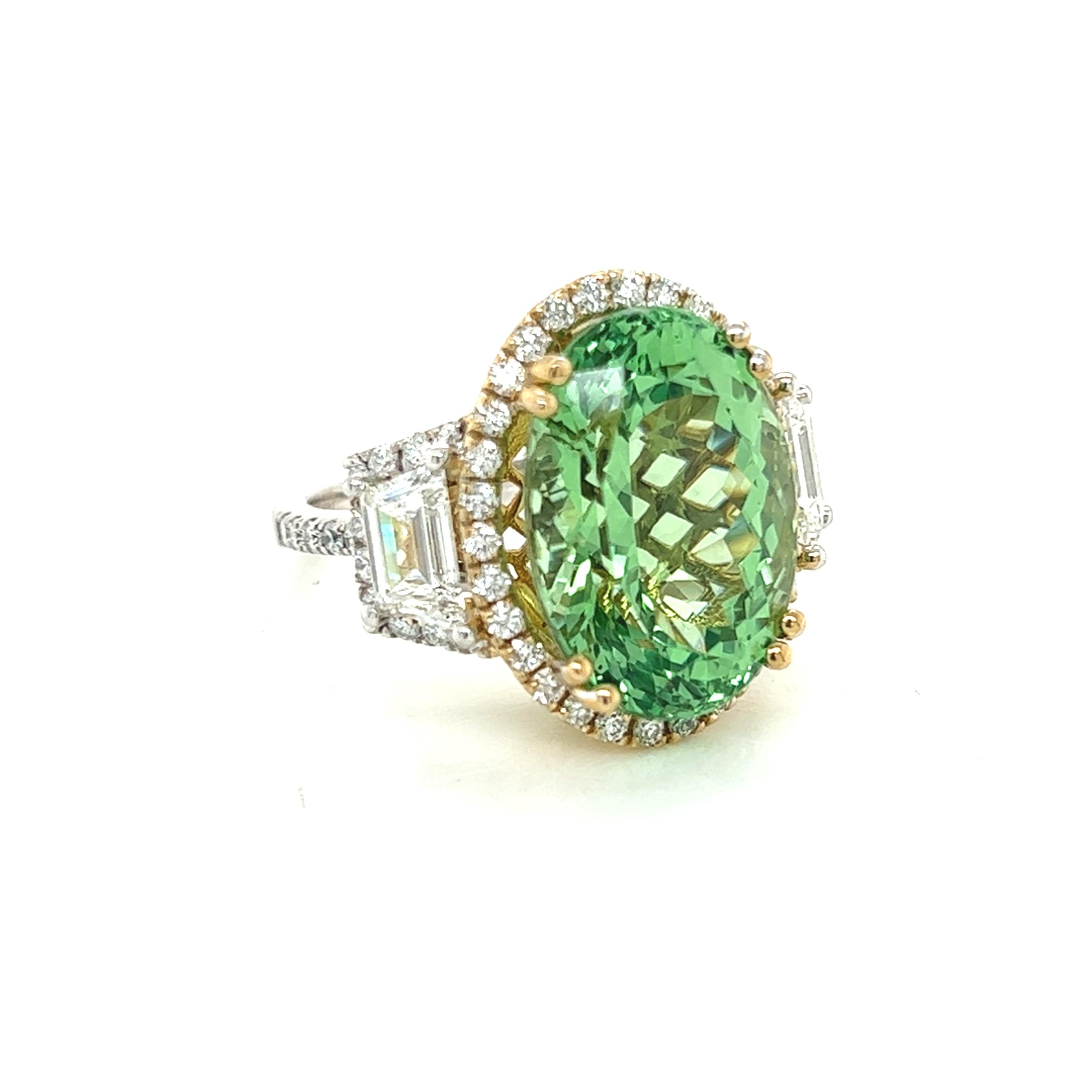 This stunning three stone ring features a sparkling 14.82 carat tsavorite garnet center stone, accented by two sparkling 1.26 carat diamond trapezoids. The ring is further adorned with 0.86 carats of sparkling diamond melee, making it the perfect